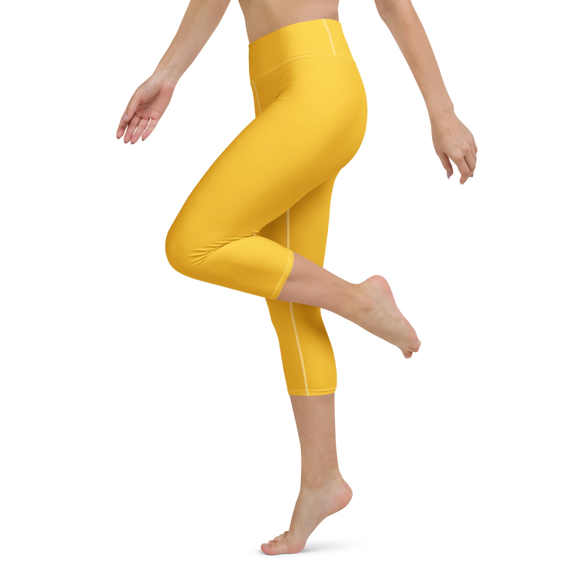 Bright yellow buttery soft high-rise yoga capri leggings with moisture-wicking fabric and subtle white side stitching