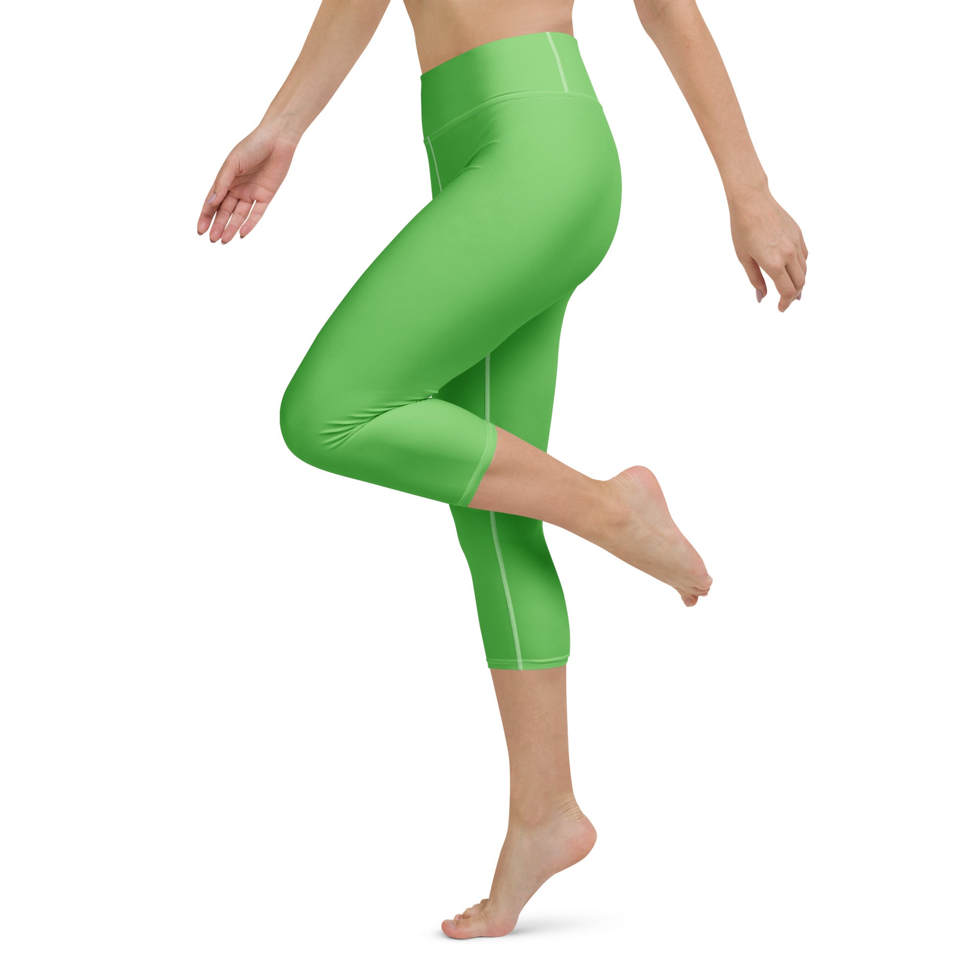 Bright green buttery soft high-rise yoga capri leggings with subtle white stitching and moisture-wicking fabric