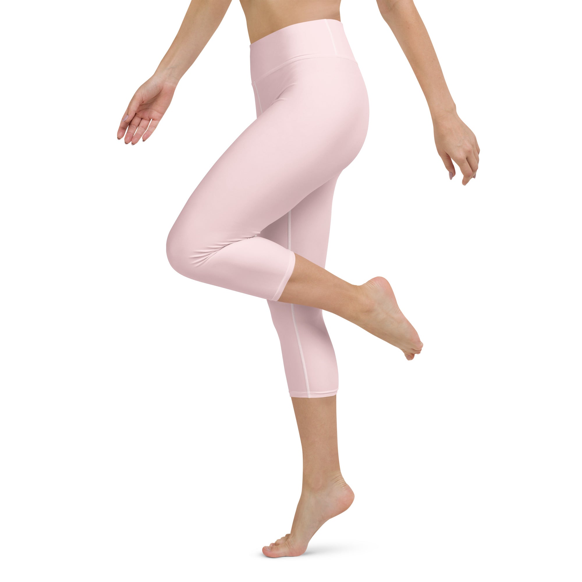 Women’s light pink buttery soft yoga capri leggings with high-rise waistband and smooth stretchy fabric