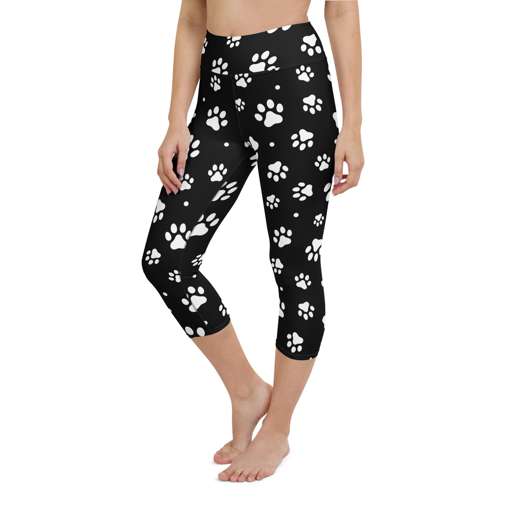 Black capri leggings with white paw prints featuring buttery soft, high-rise, moisture-wicking yoga activewear material