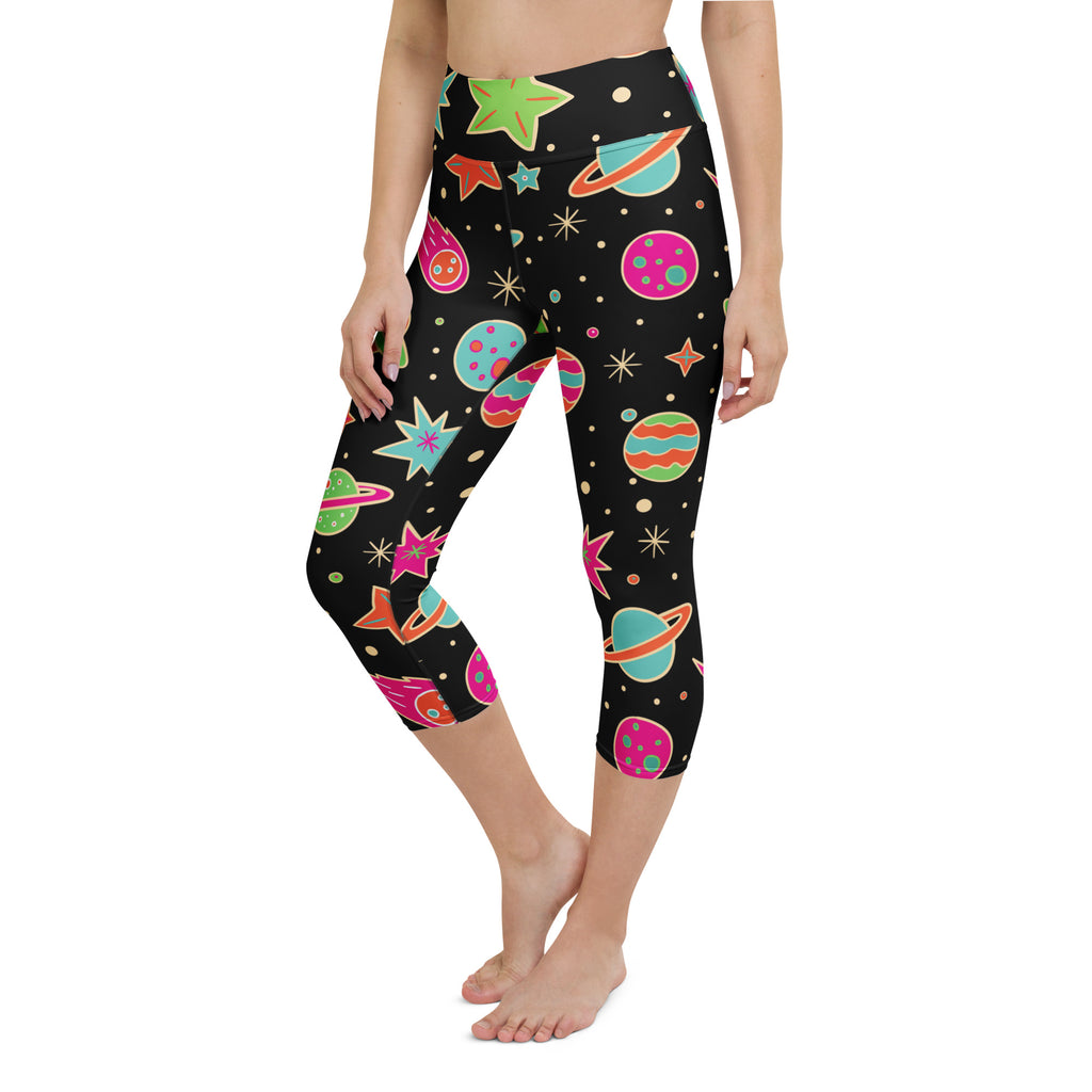 Black capri leggings with vibrant cartoon space theme featuring colorful planets stars and comets in soft stretch fabric