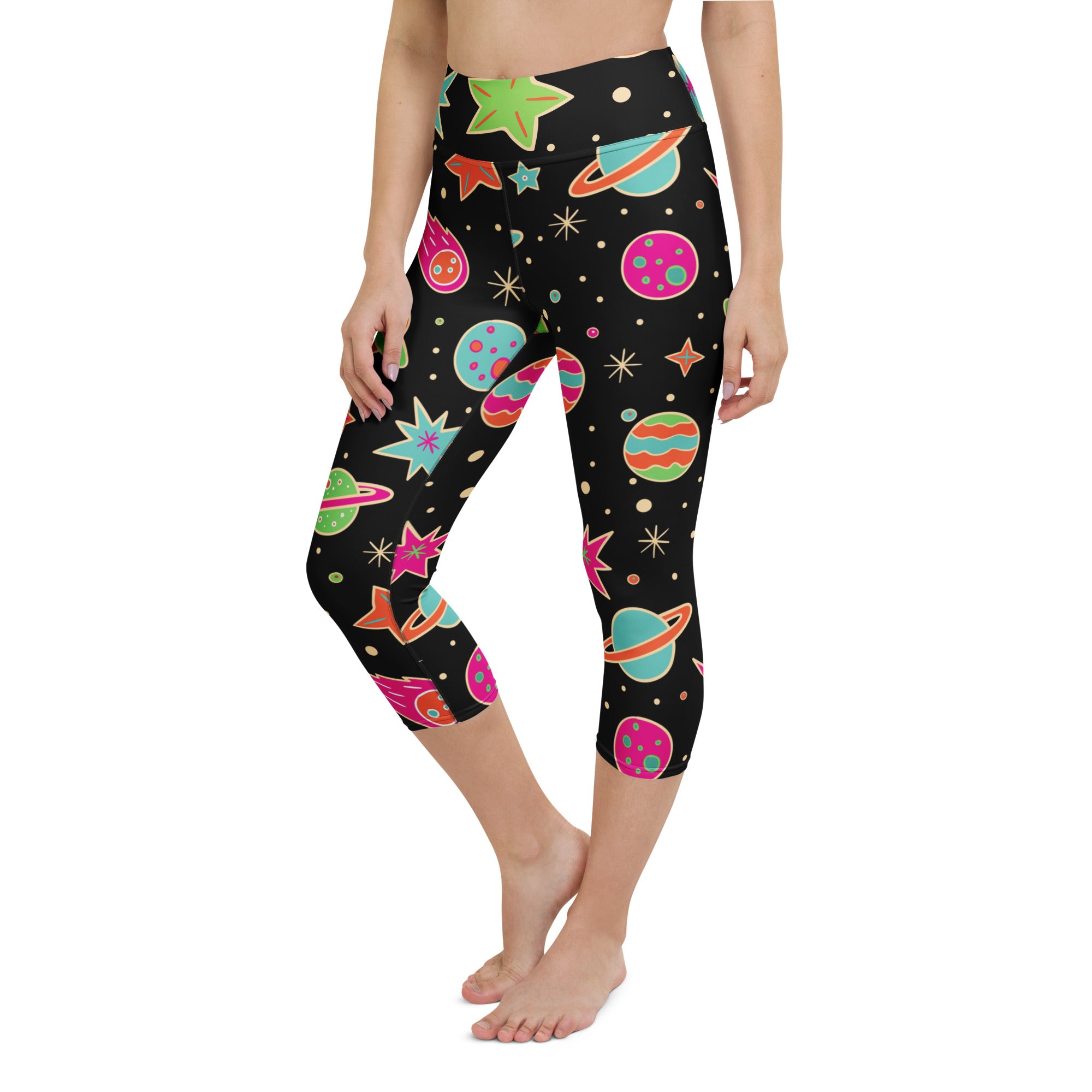 Black capri leggings with vibrant cartoon space theme featuring colorful planets stars and comets in soft stretch fabric