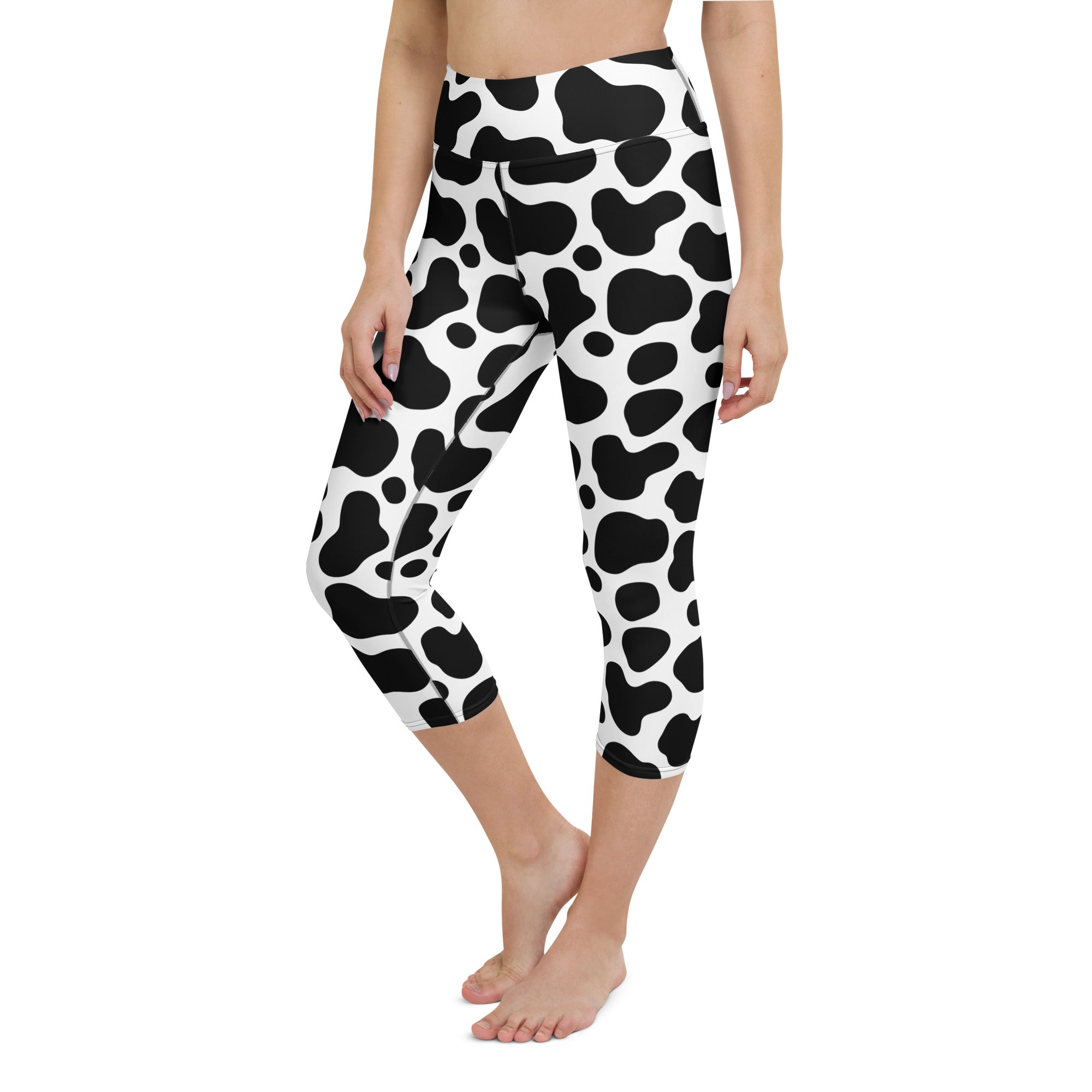 Women’s high-rise cow print capri leggings in black and white soft buttery stretch fabric for yoga and activewear