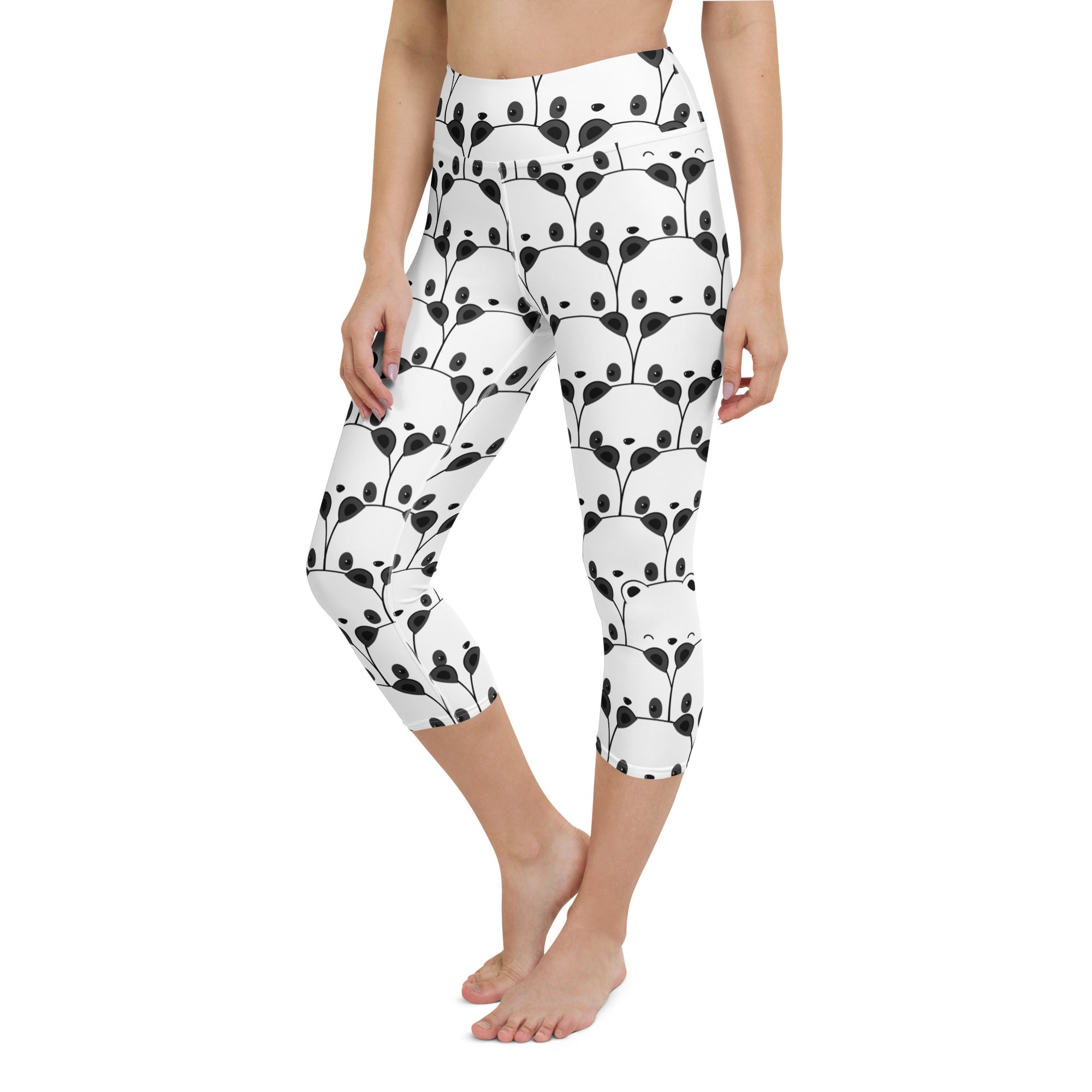 White capri leggings with high-rise waistband featuring playful black panda faces in leafy vines soft stretch fabric