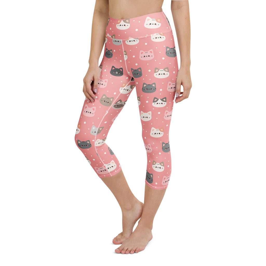 Pink capri leggings with playful cartoon cat faces and polka dots made from buttery soft, moisture-wicking fabric