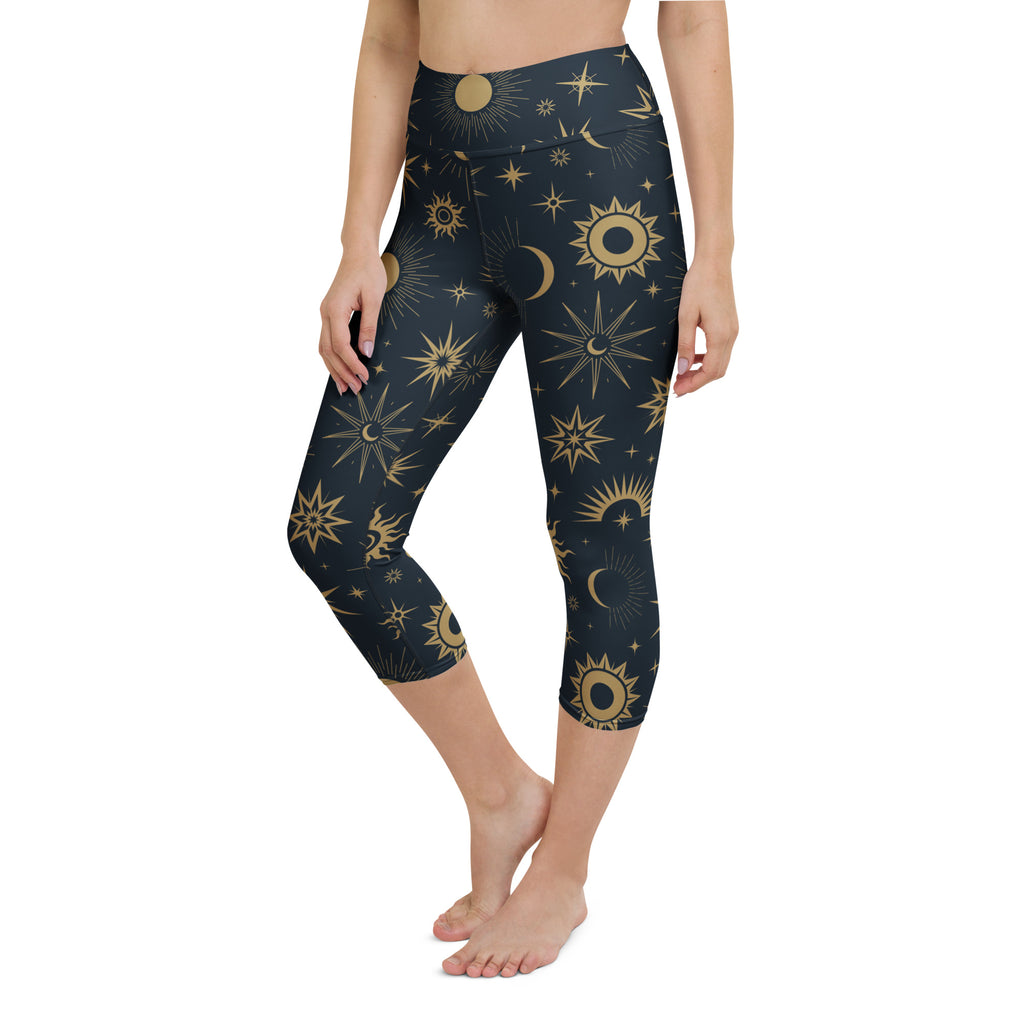 Dark blue high-rise capri leggings with vibrant gold celestial sun moon stars pattern buttery soft moisture-wicking fabric