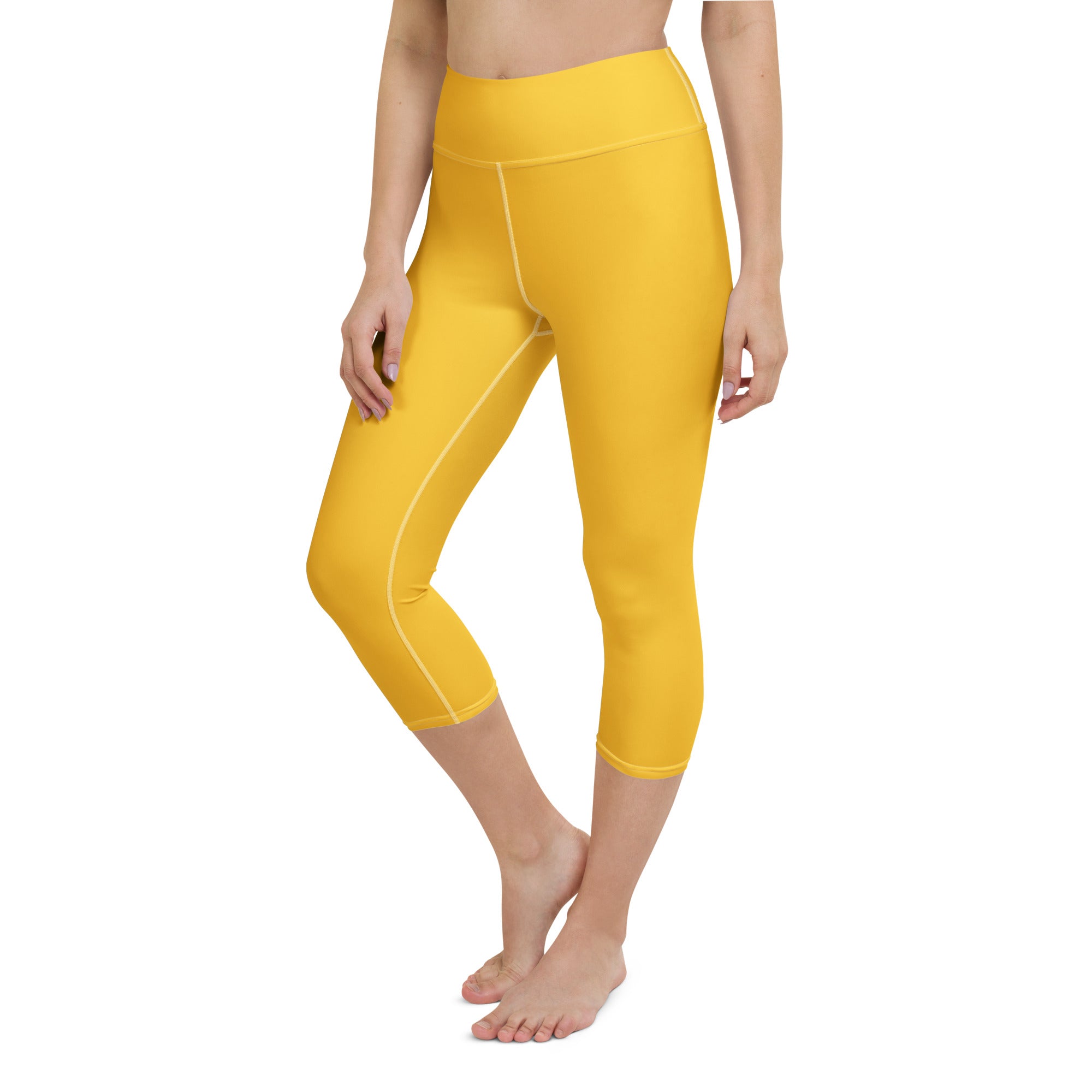 Bright yellow high-rise buttery soft yoga capri leggings with white stitching and moisture-wicking stretch fabric