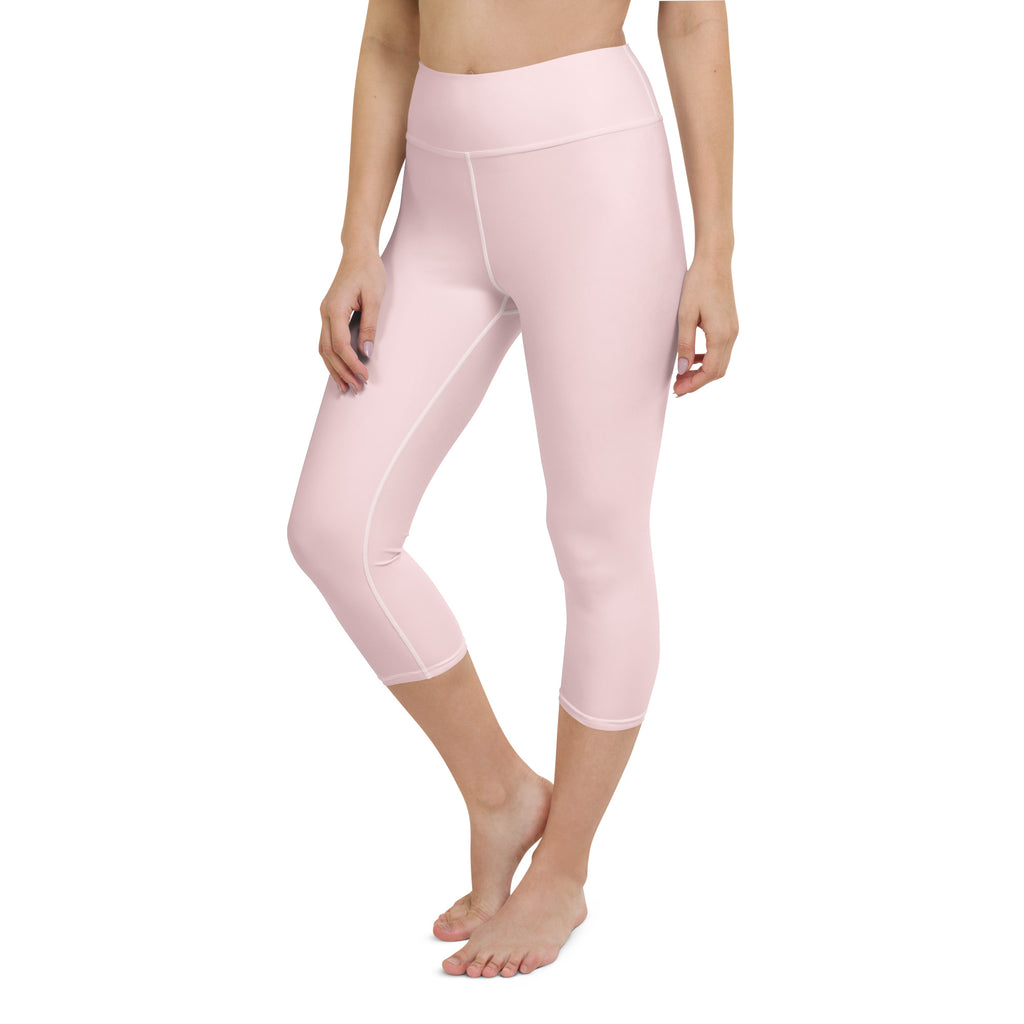 Soft pink high-waisted capri leggings made of smooth stretchy fabric perfect for yoga and activewear use