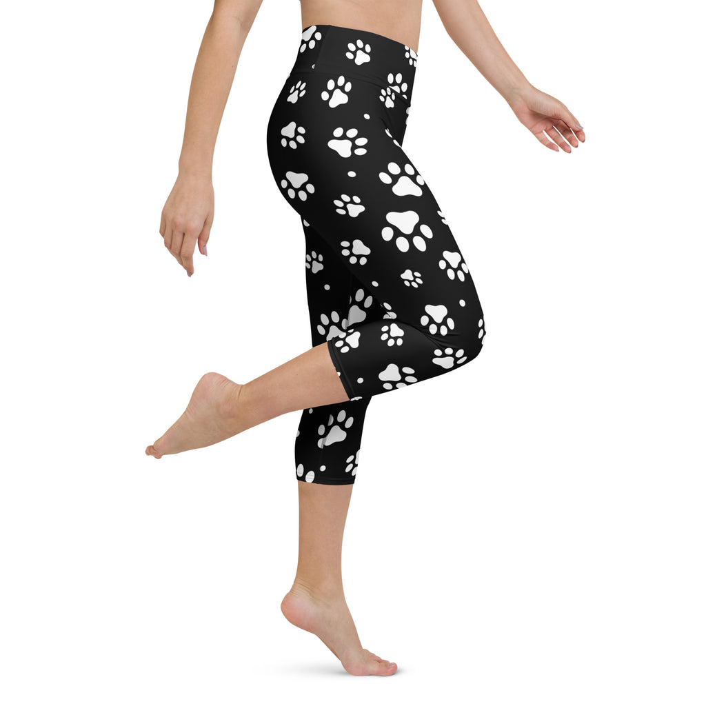 Black high-rise capri leggings with white paw prints made from buttery soft moisture-wicking stretch fabric