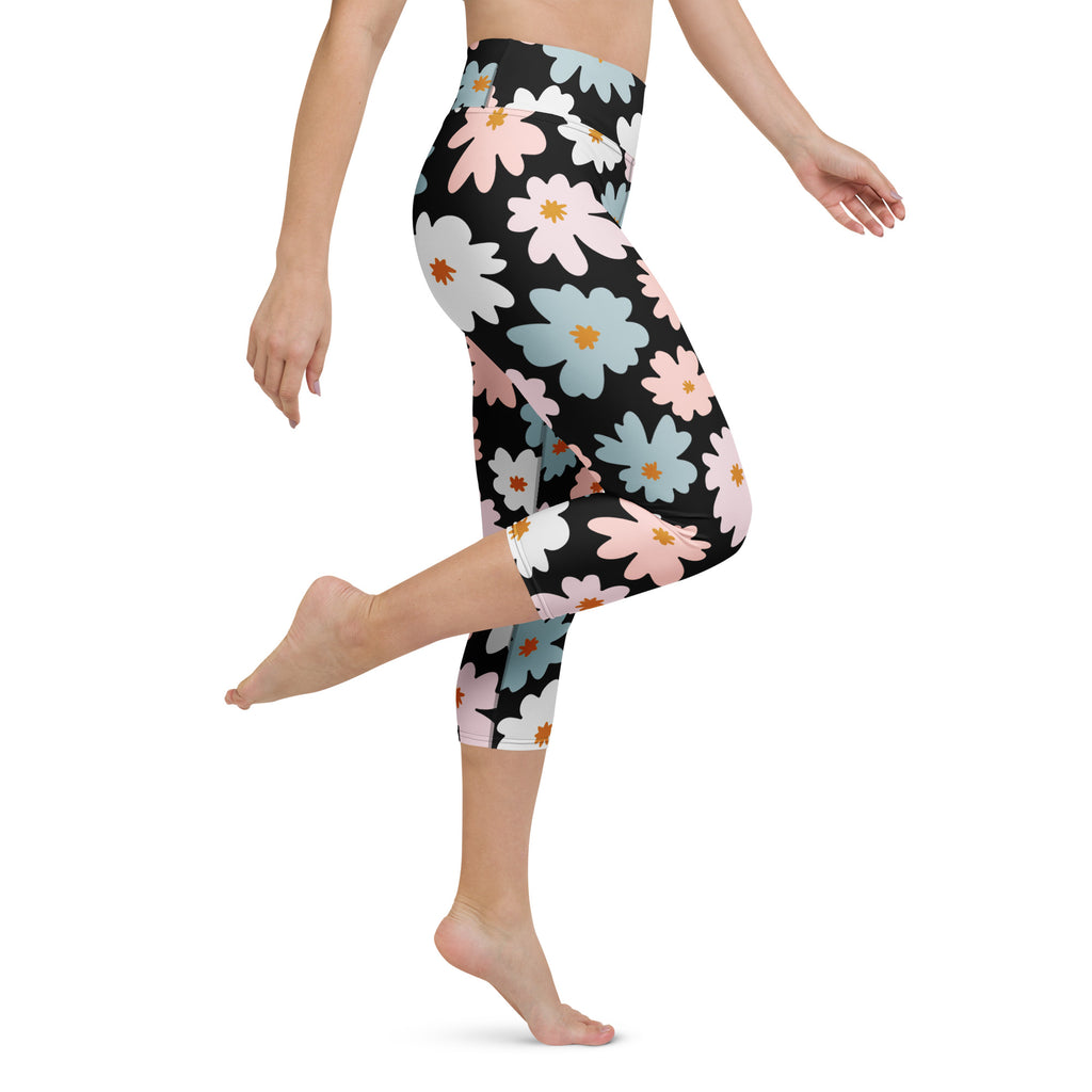 Women’s high-rise black capri leggings with vibrant pink white and light blue daisy floral pattern buttery soft fabric