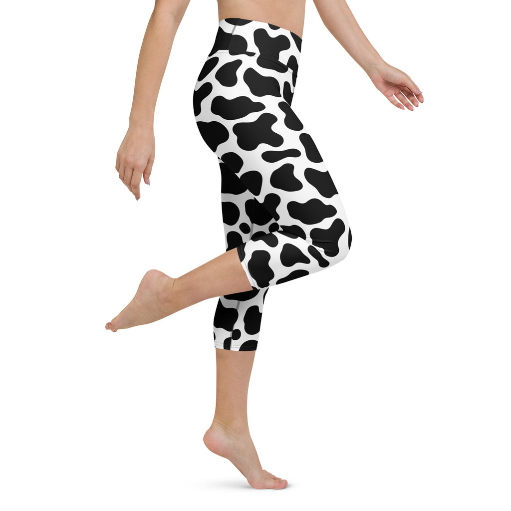 Women’s black and white cow print buttery soft high-rise yoga capri leggings with moisture-wicking stretch fabric