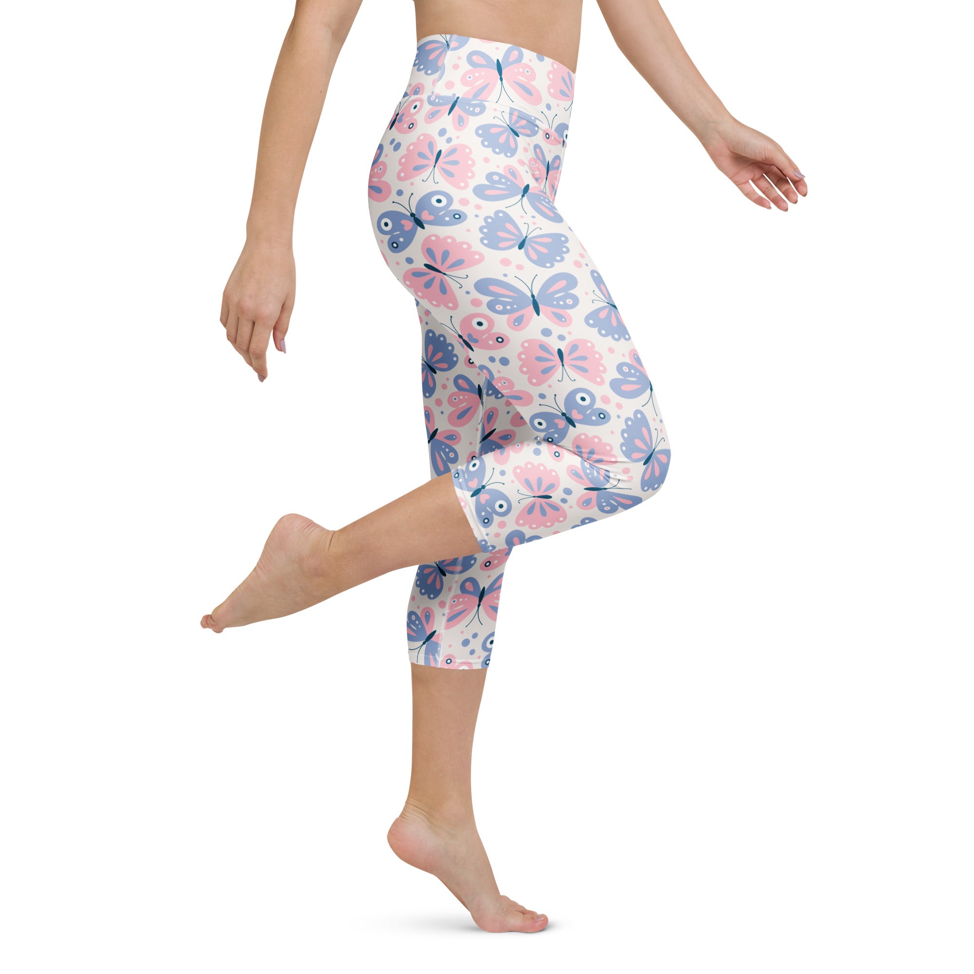 Women’s pastel pink and lavender butterfly high-rise yoga capri leggings made of buttery soft moisture-wicking fabric