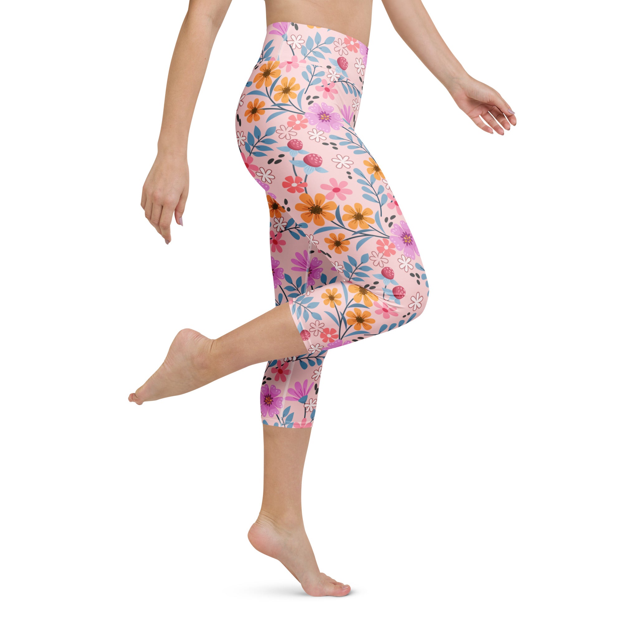 Women’s pink floral buttery soft high-rise yoga capri leggings with vibrant flowers and moisture-wicking fabric