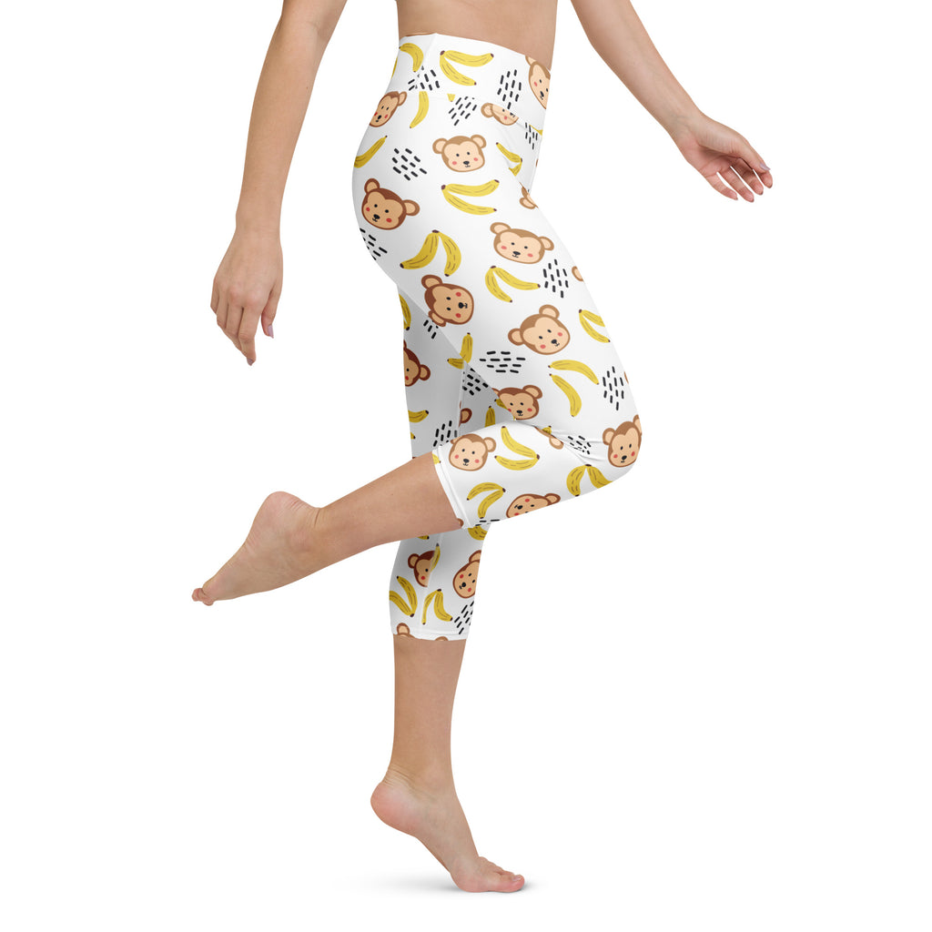 White women’s high-rise buttery soft yoga capri leggings with brown monkey and yellow banana pattern and moisture-wicking fabric