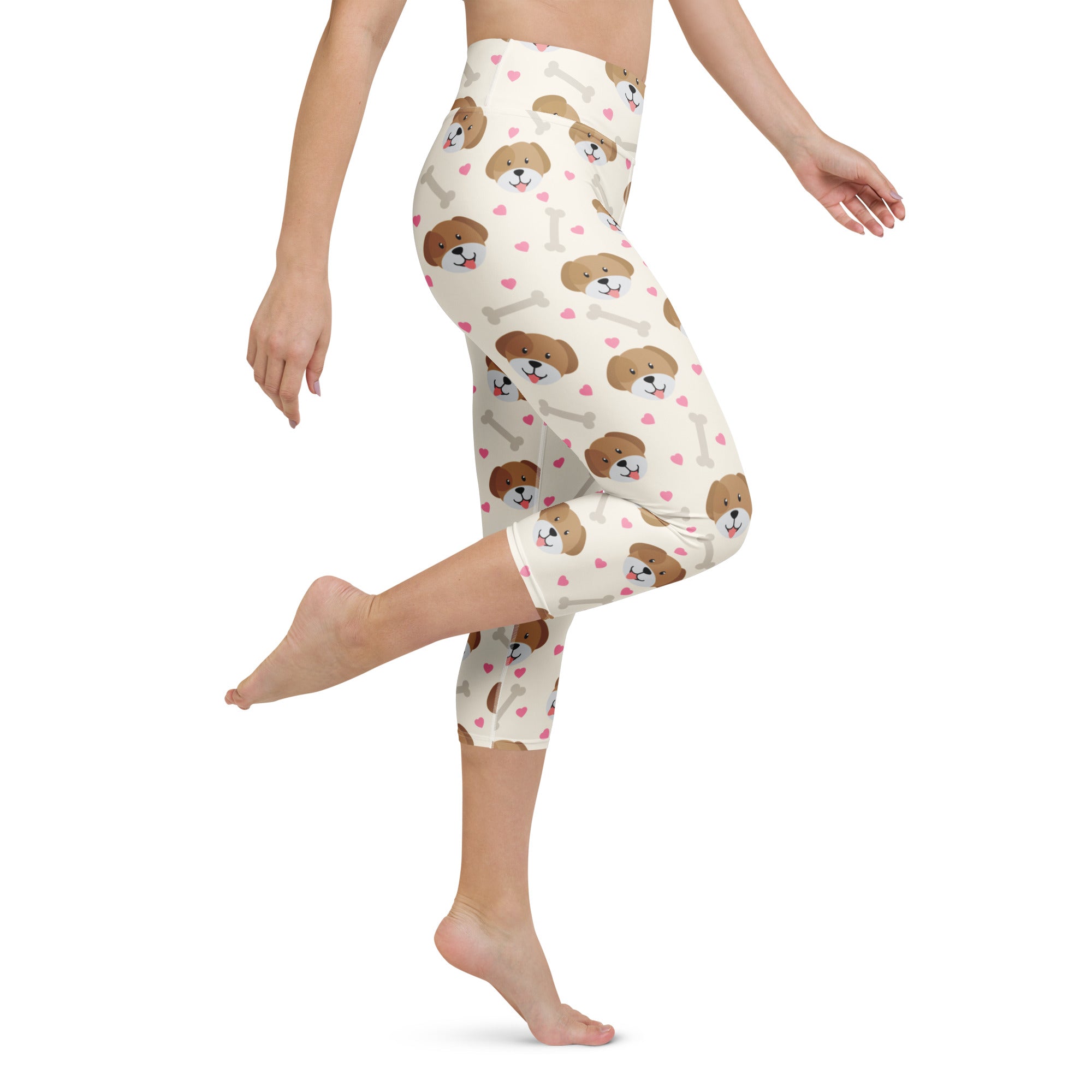 Cream-colored high-rise buttery soft yoga capri leggings with brown puppy faces pink hearts and white bones pattern