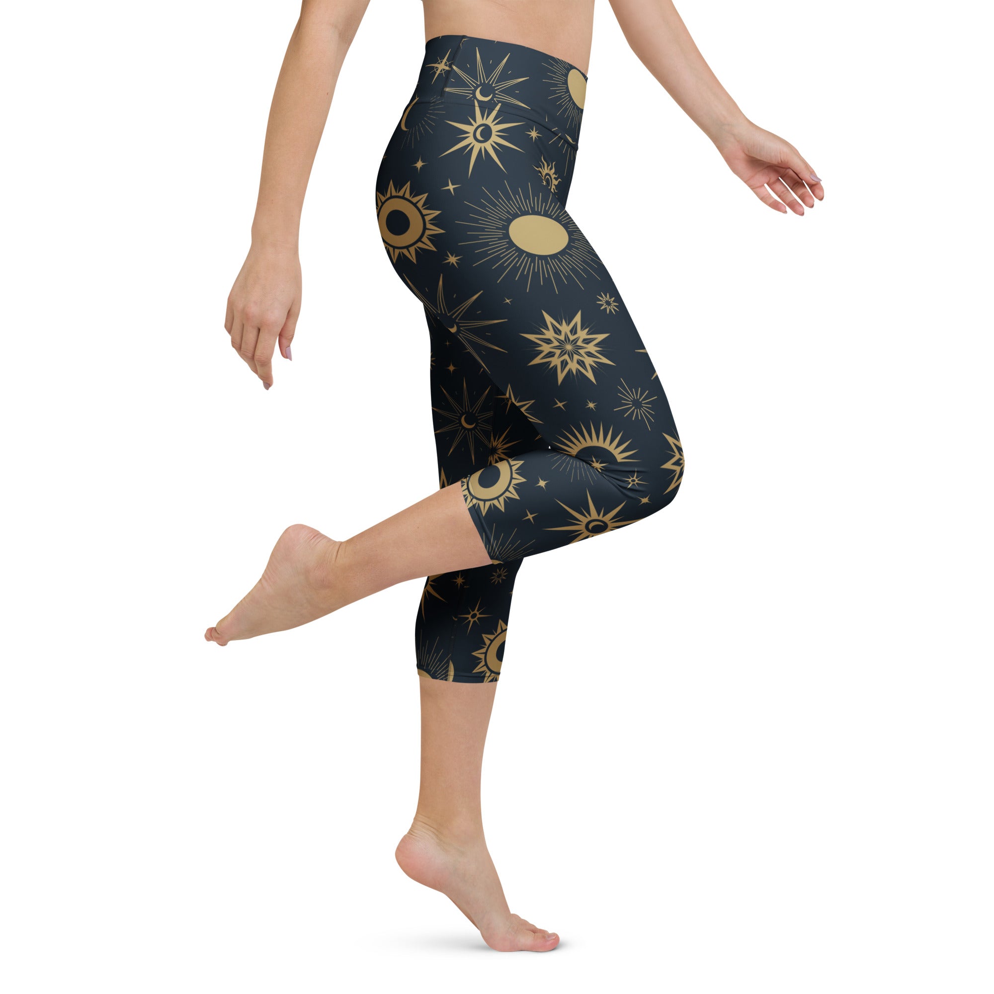 Dark blue high-rise buttery soft yoga capri leggings with gold sun moon and star celestial pattern