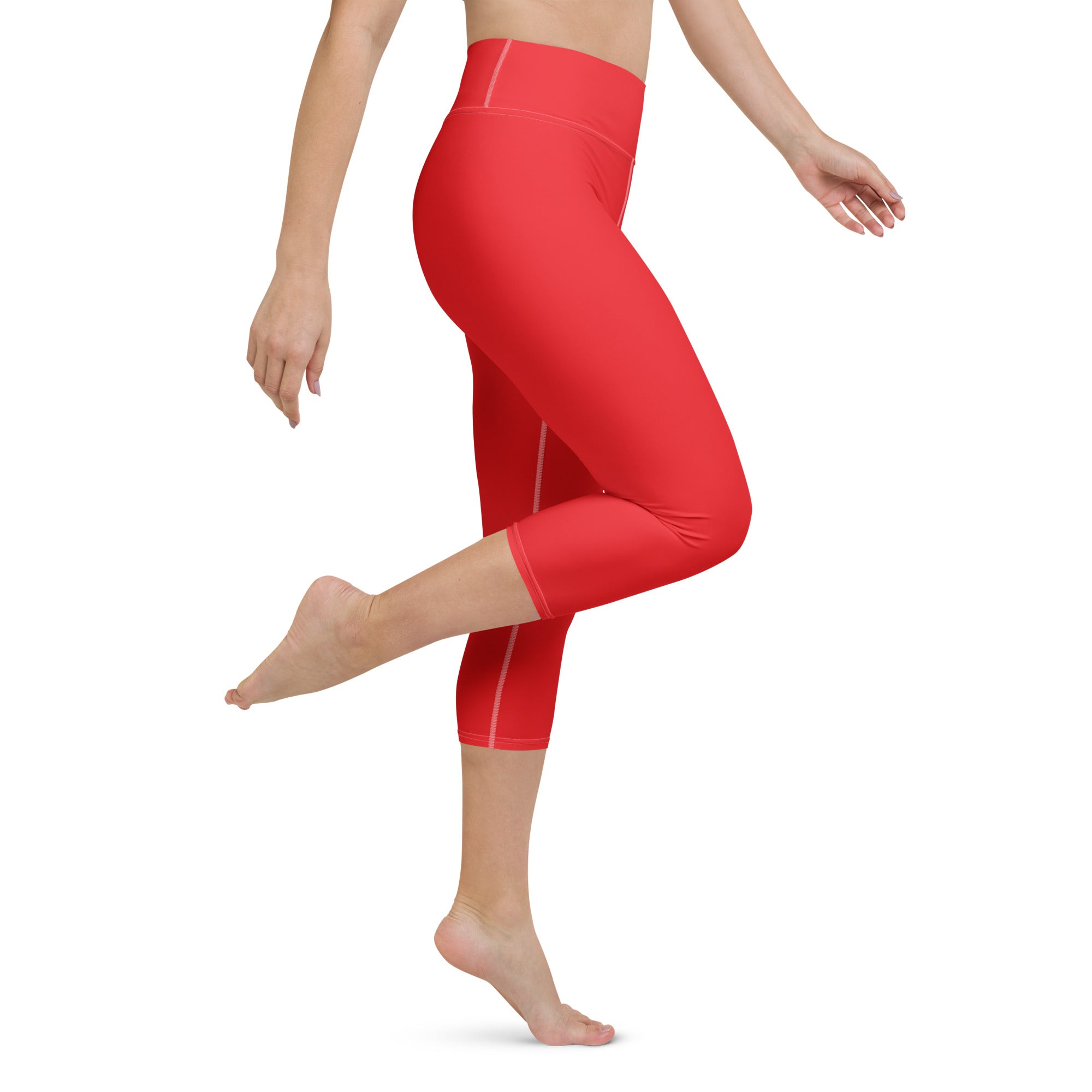 Women’s red high-rise buttery soft yoga capri leggings with moisture-wicking fabric and subtle white side stripes