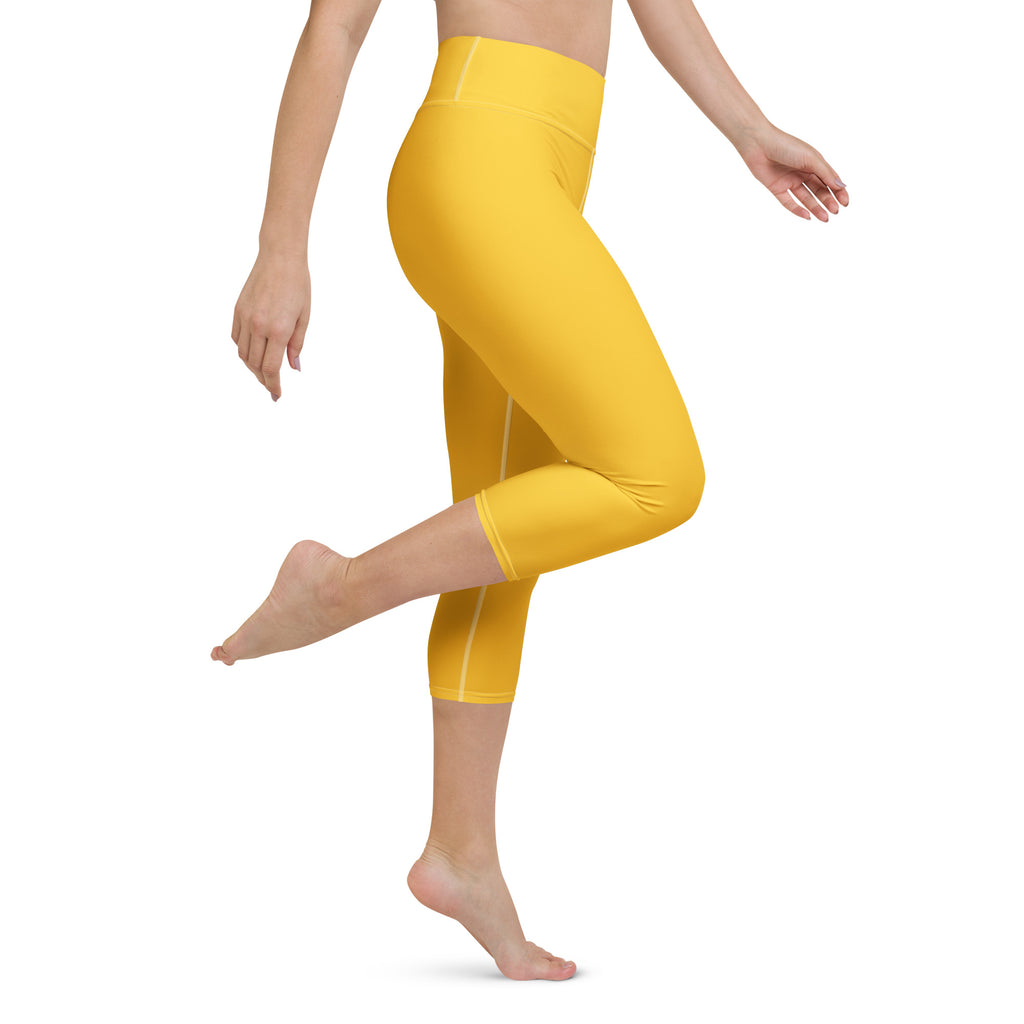 Women’s bright yellow buttery soft high-rise yoga capri leggings with subtle white side stripes and moisture-wicking fabric