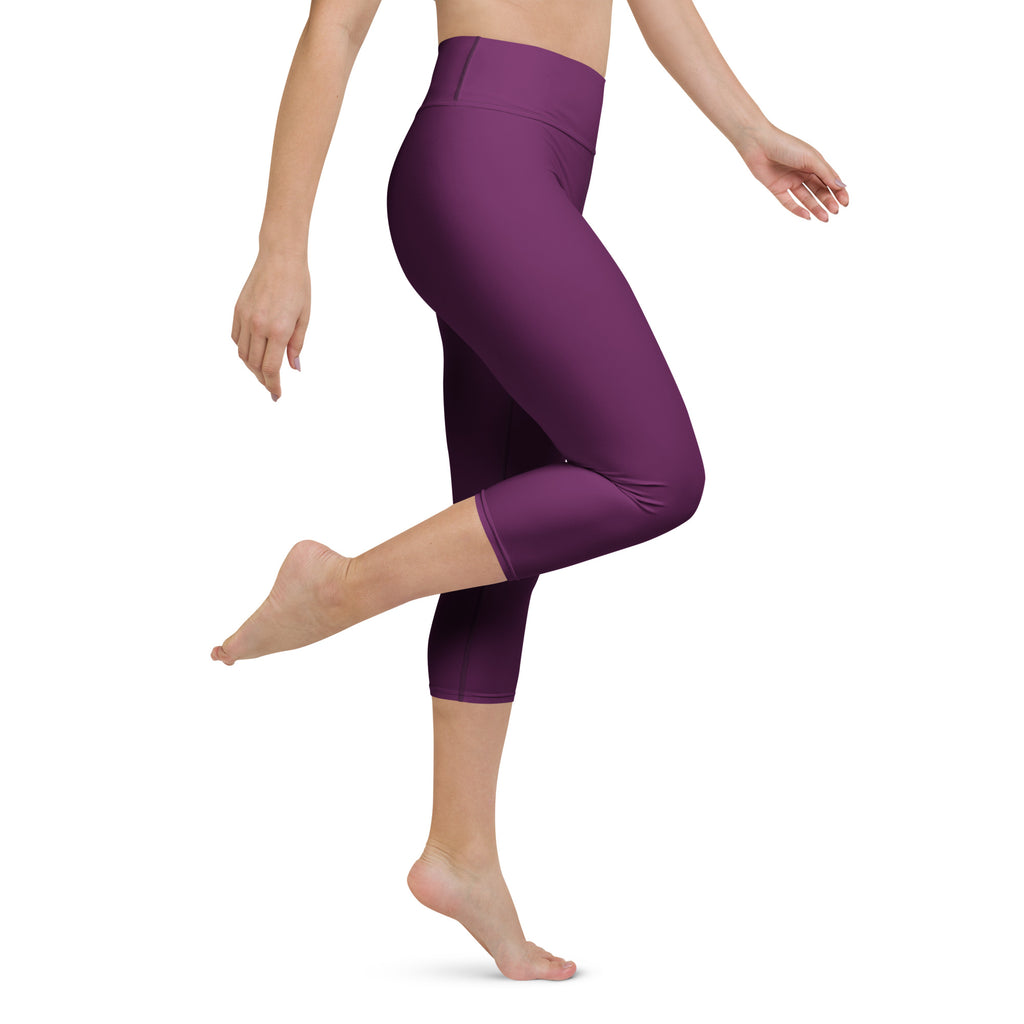 Woman wearing plum purple high-waisted buttery soft yoga capri leggings with moisture-wicking stretch fabric