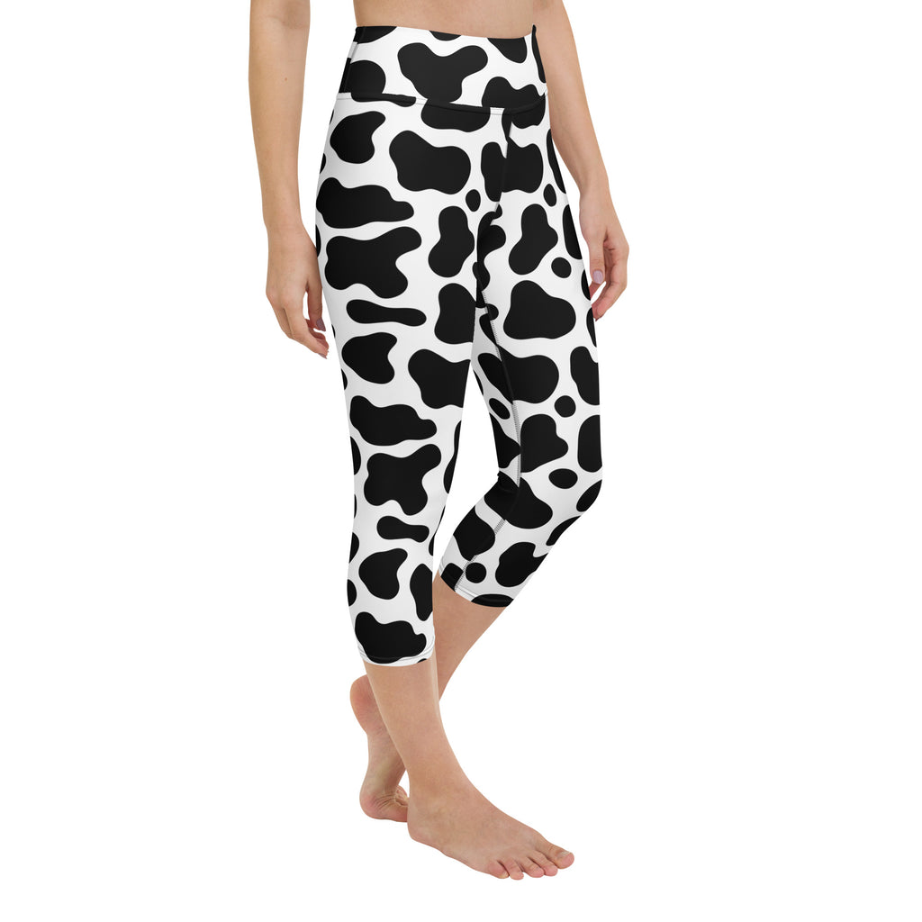 Women’s cow print buttery soft high-rise capri leggings in black and white moisture-wicking stretch fabric