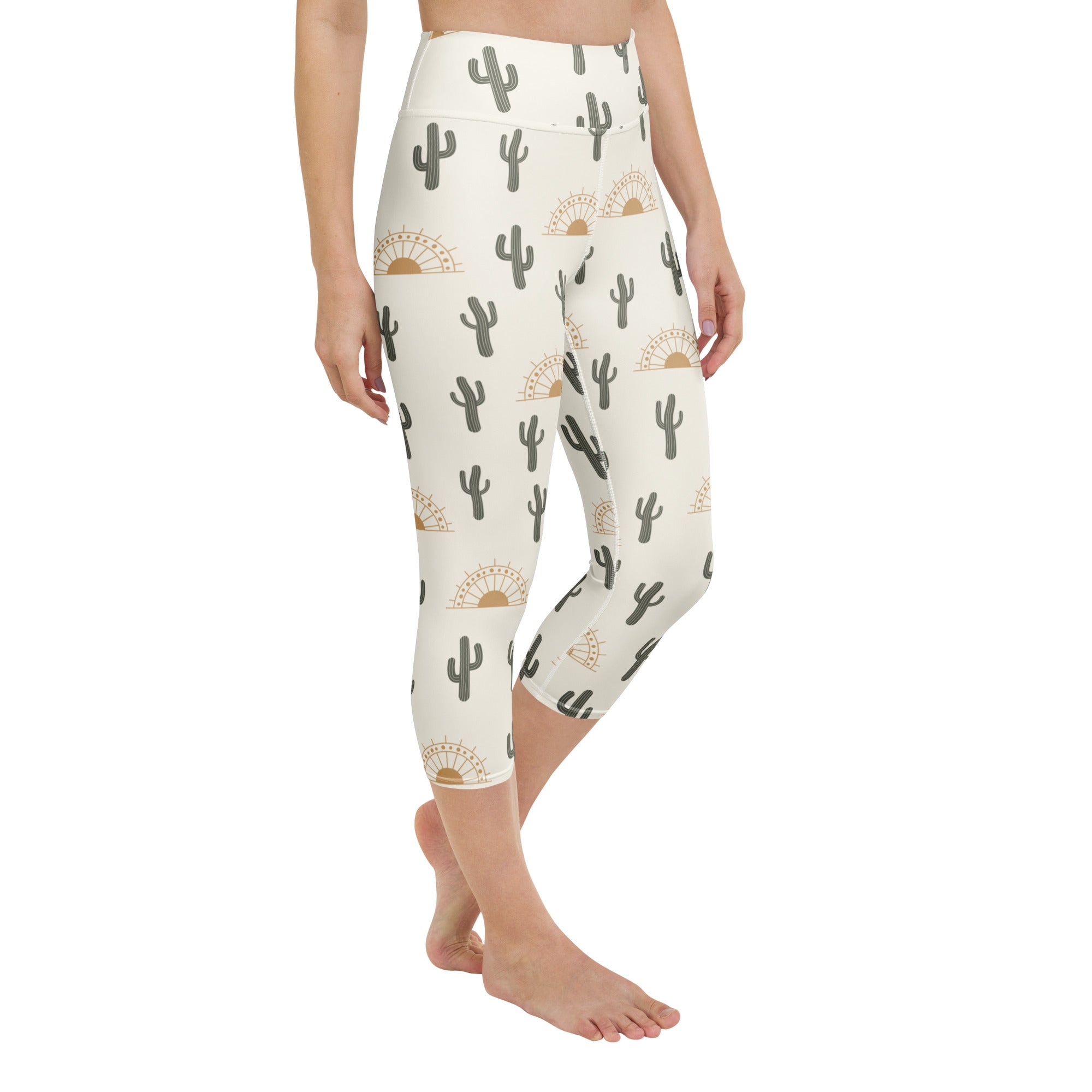 Cream-colored high-rise buttery soft yoga capri leggings with gray cacti and gold sunburst moisture-wicking pattern