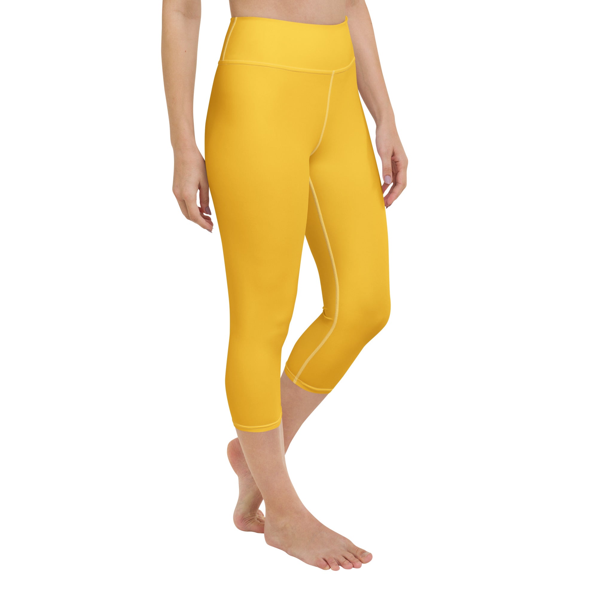 Bright yellow high-waisted buttery soft yoga capri leggings made of stretchy moisture-wicking fabric
