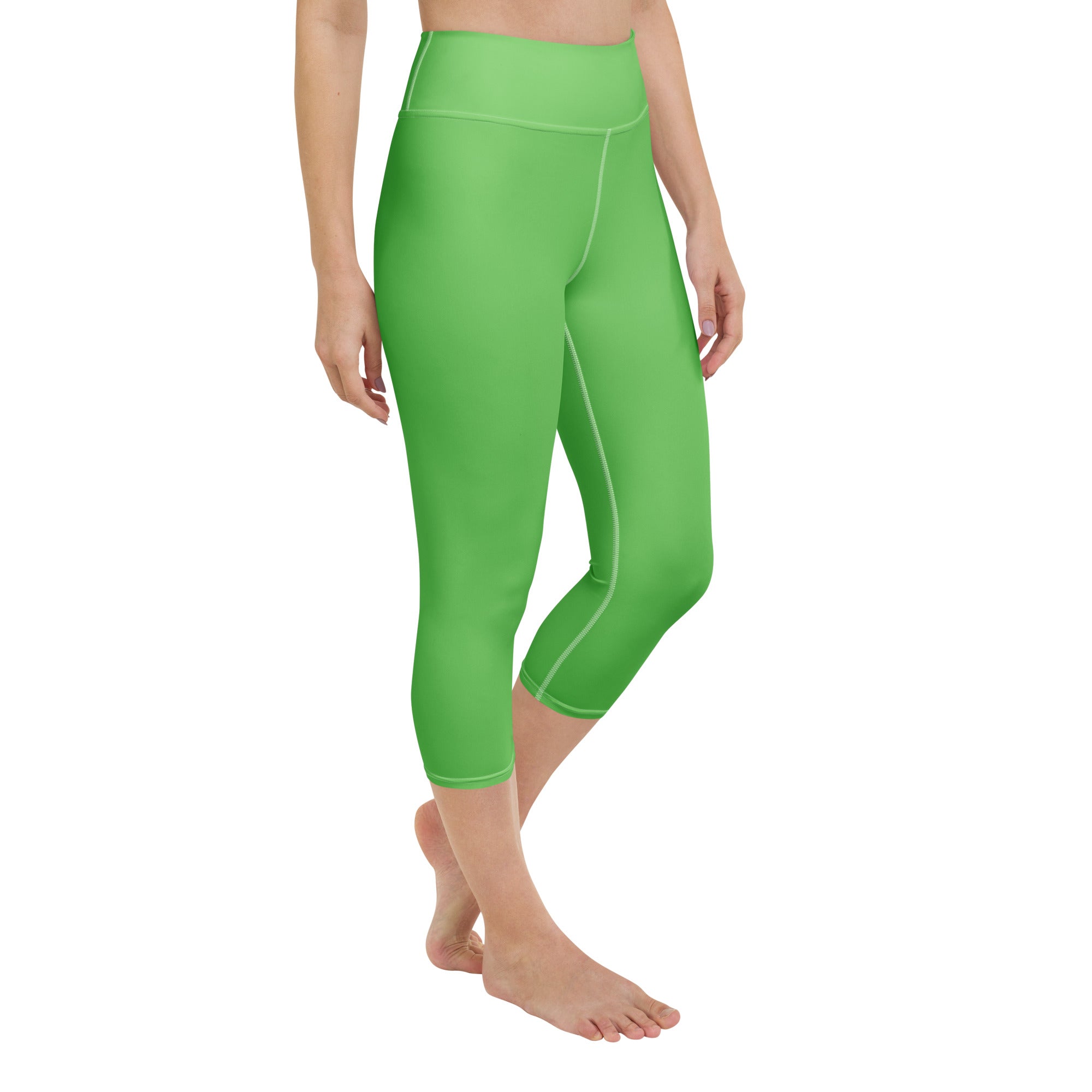 Bright green high waisted buttery soft yoga capri leggings with subtle seam detailing and moisture wicking fabric