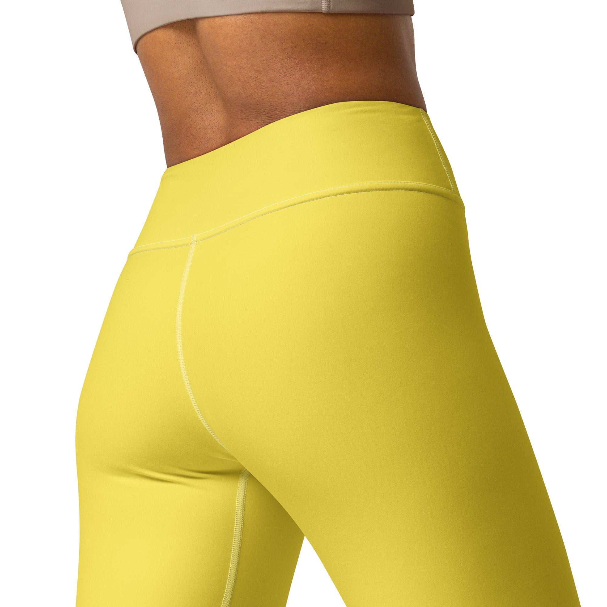 Bright yellow high-waisted women’s yoga leggings made from buttery soft stretchy fabric with subtle seam detailing