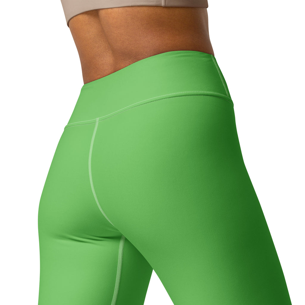 Women’s green buttery soft yoga leggings with bright high waist and smooth stretchy fabric with white seam stitching