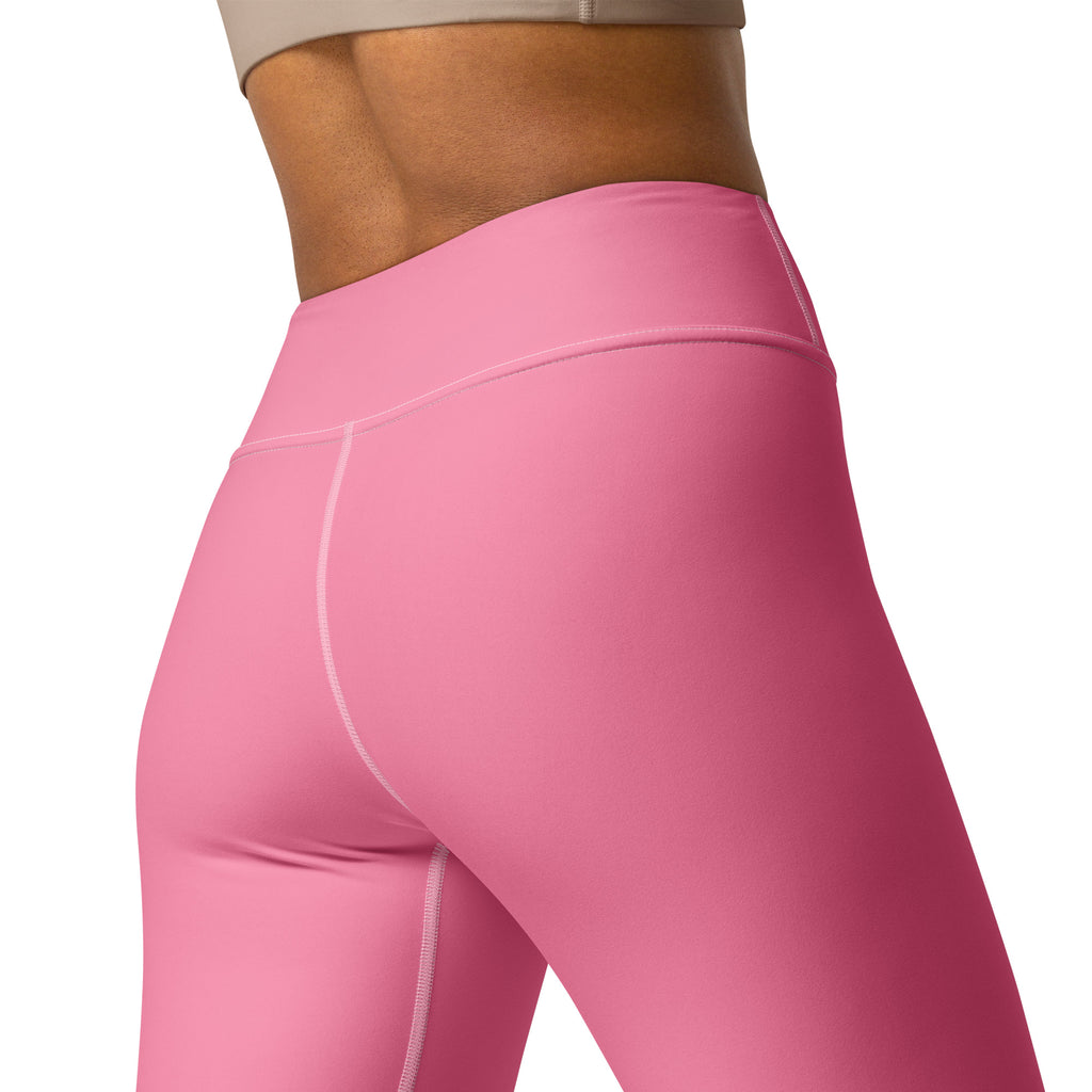 Women’s pink buttery soft yoga leggings in smooth stretchy fabric with subtle white stitching along the seams