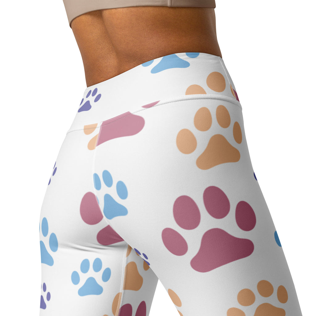 White high-waisted buttery soft yoga leggings with colorful blue pink and tan paw print pattern for women
