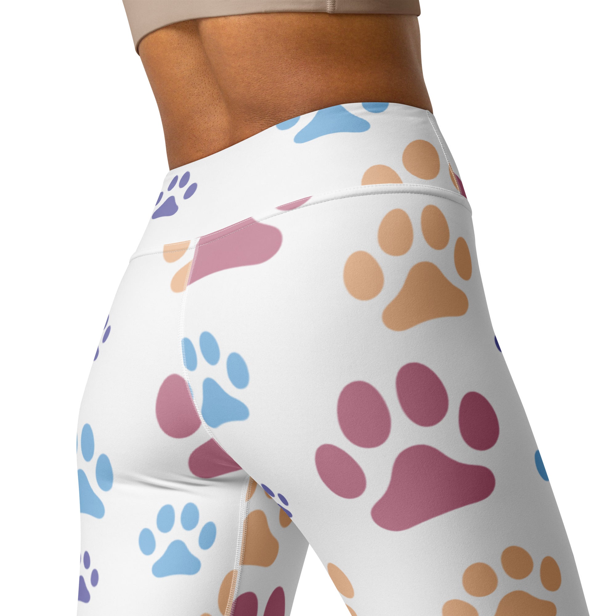 White high-waisted buttery soft yoga leggings with colorful blue pink and tan paw print pattern for women