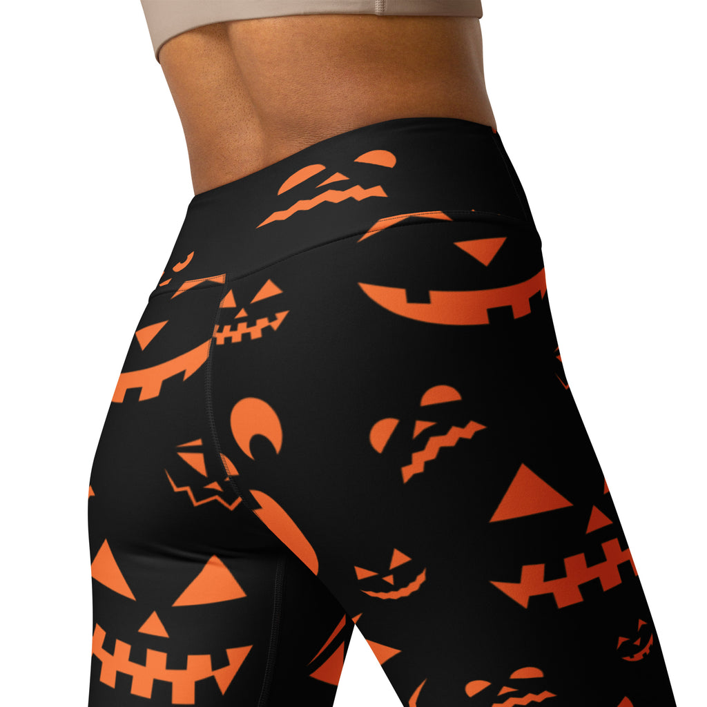 Black high-waisted buttery soft leggings with vibrant orange jack-o-lantern faces for women’s halloween yogawear