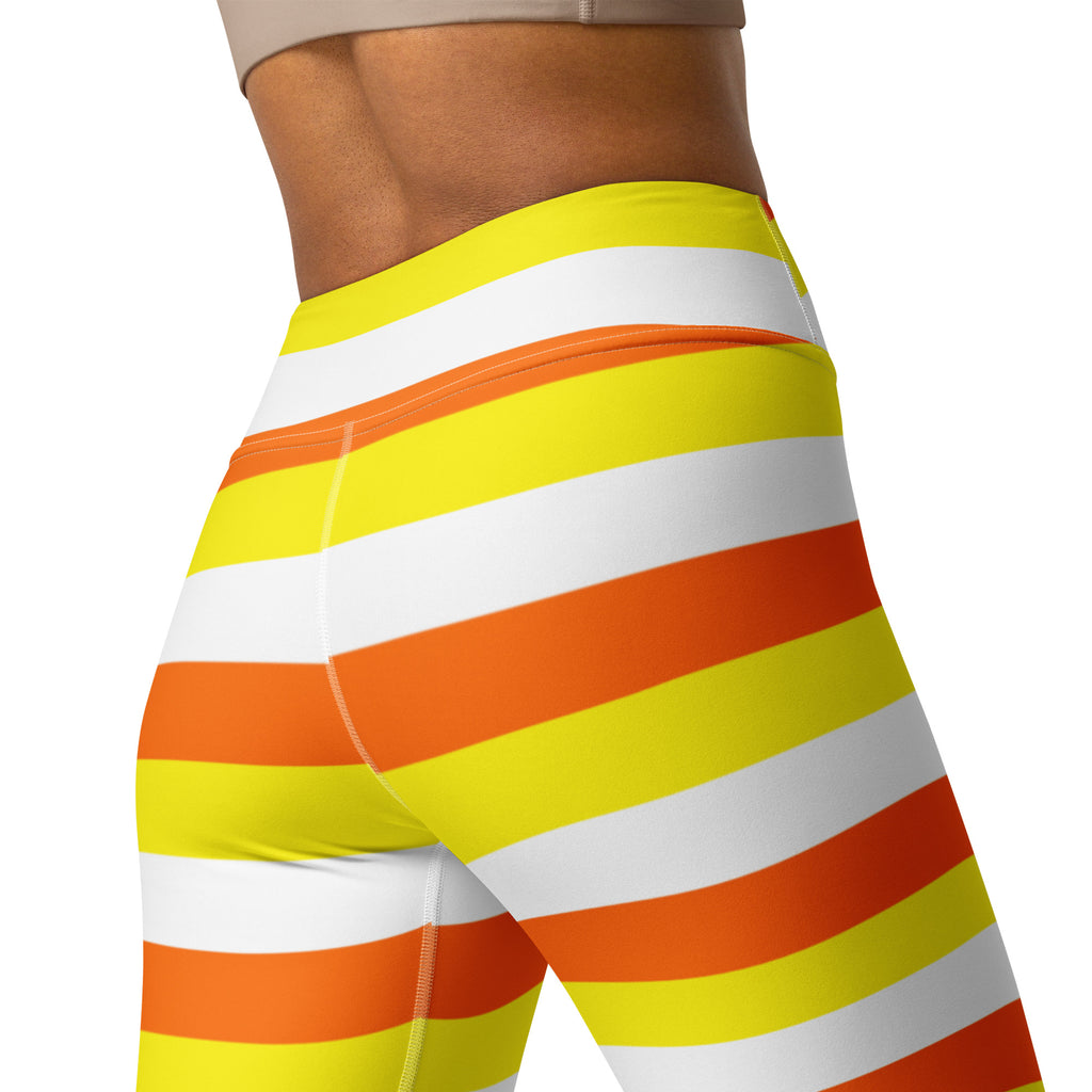 High-waisted buttery soft women’s yoga leggings with bold yellow orange and white candy corn stripes for Halloween