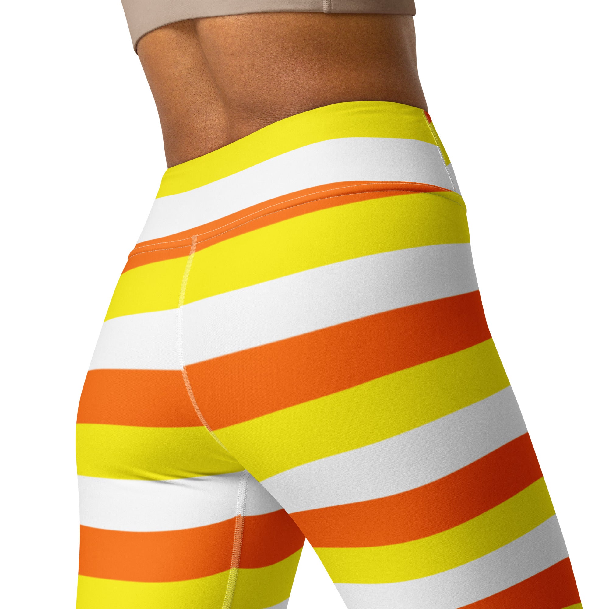 High-waisted buttery soft women’s yoga leggings with bold yellow orange and white candy corn stripes for Halloween