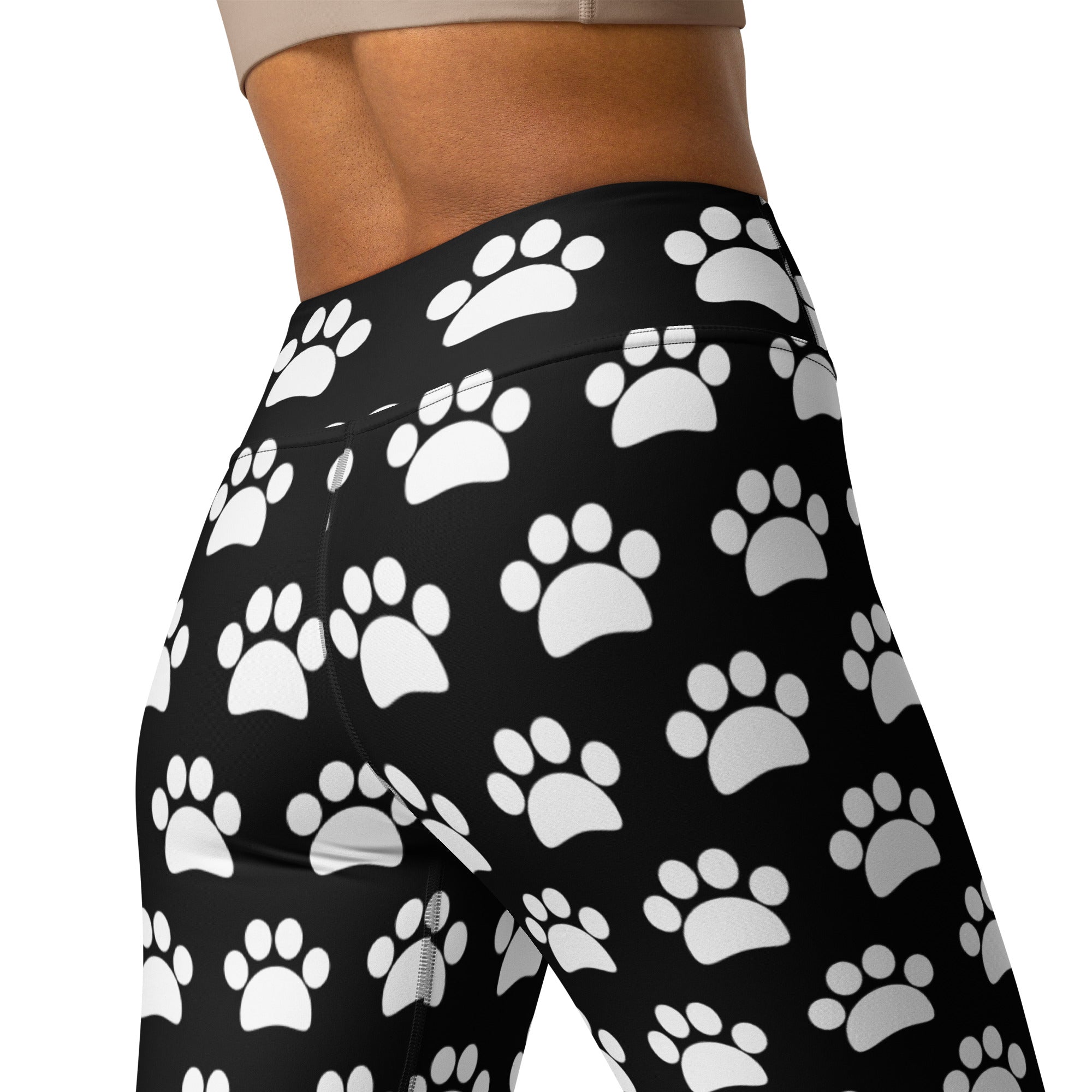 Women’s black high-waisted buttery soft yoga leggings with white paw print pattern for comfortable activewear
