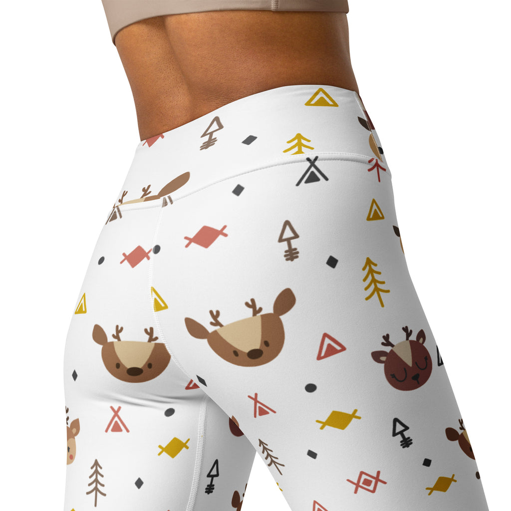 White high-waisted buttery soft yoga leggings with brown deer faces yellow and red geometric shapes and earthy trees