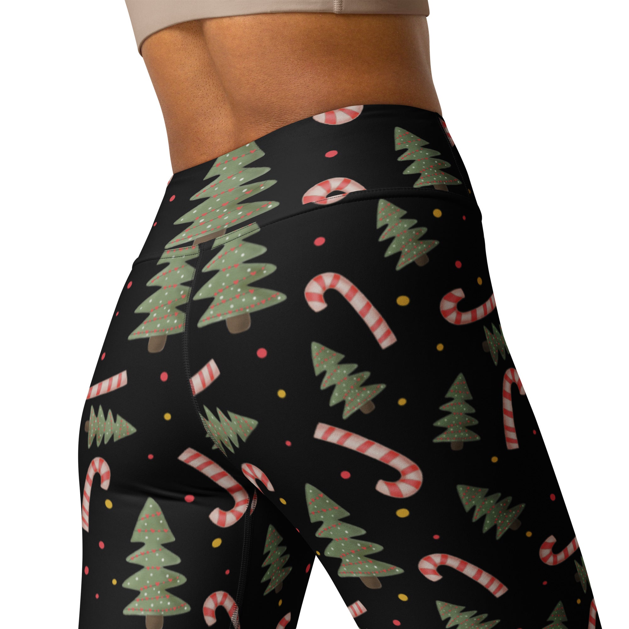Black high-waisted buttery soft yoga leggings with green pine trees and red and white candy cane pattern