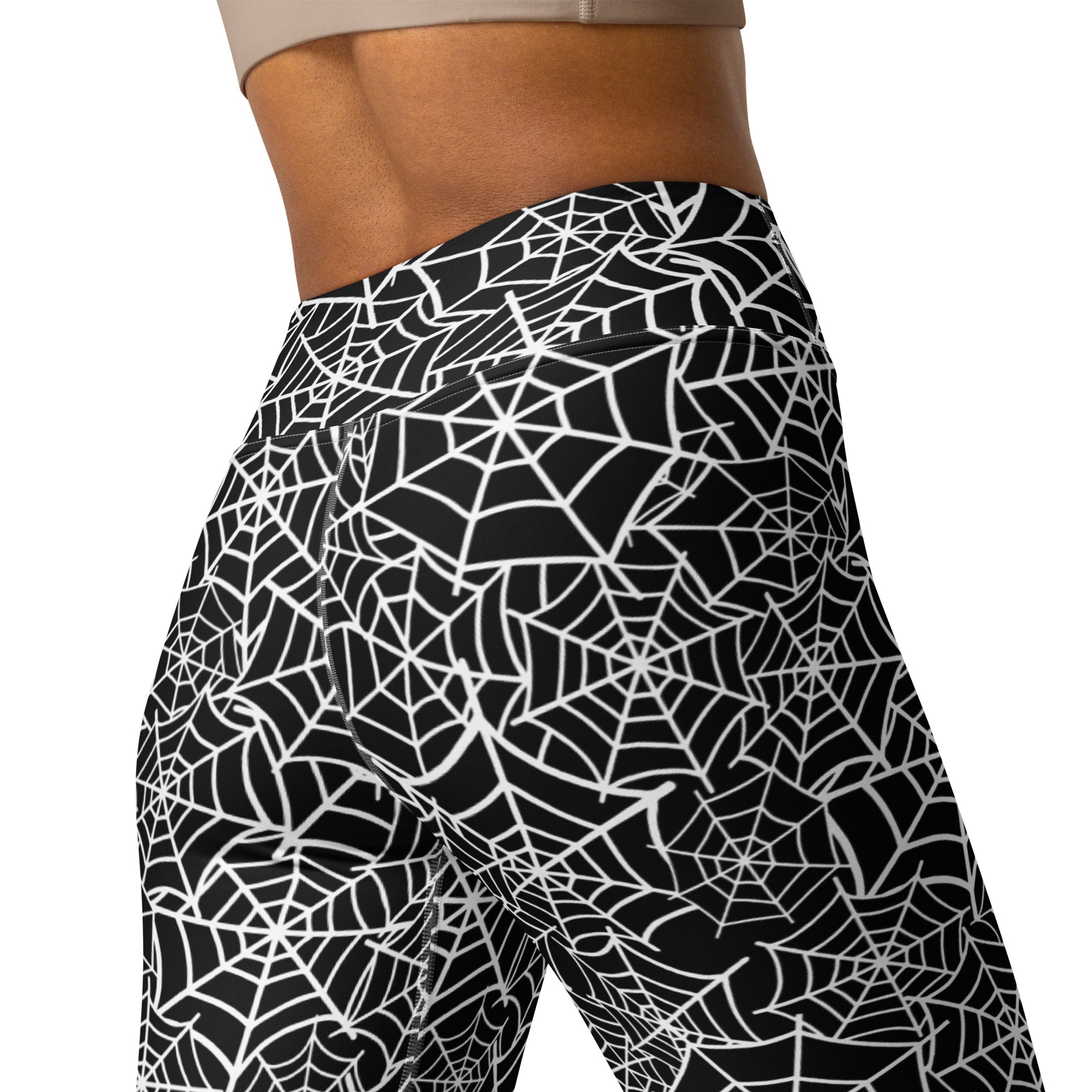Black high-waisted women’s buttery soft yoga leggings with a bold white spiderweb pattern for Halloween