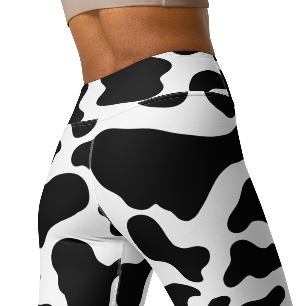 Women’s cow print high-waisted leggings in black and white buttery soft fabric perfect for yoga and casual wear