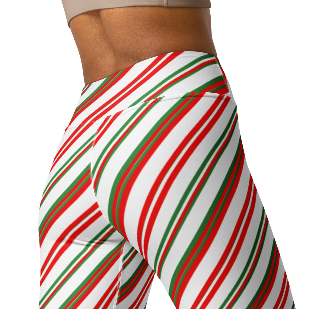 Women’s candy cane stripe high waisted buttery soft yoga leggings with red and green diagonal stripes on white background