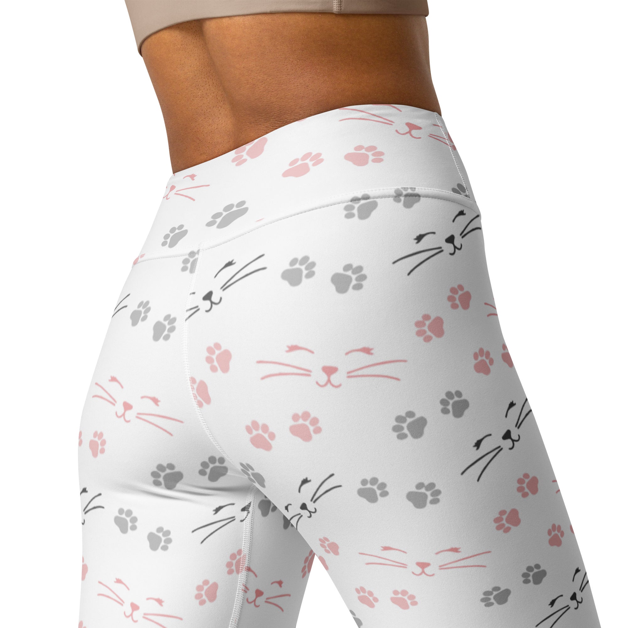 White high-waisted women’s yoga leggings with a playful pink and gray cat face and paw print pattern