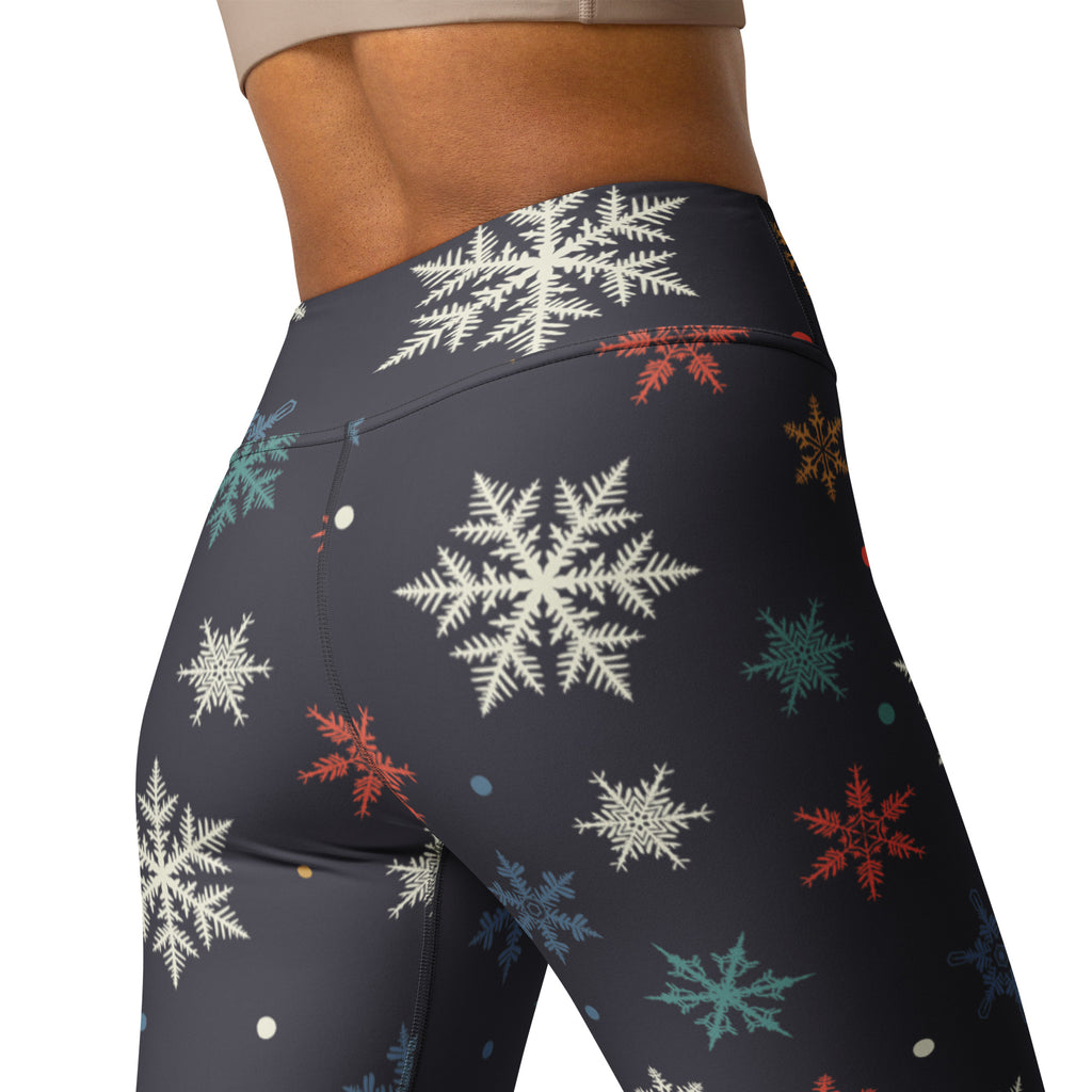 Dark gray buttery soft women’s winter yoga leggings with festive white red teal and gold snowflake pattern