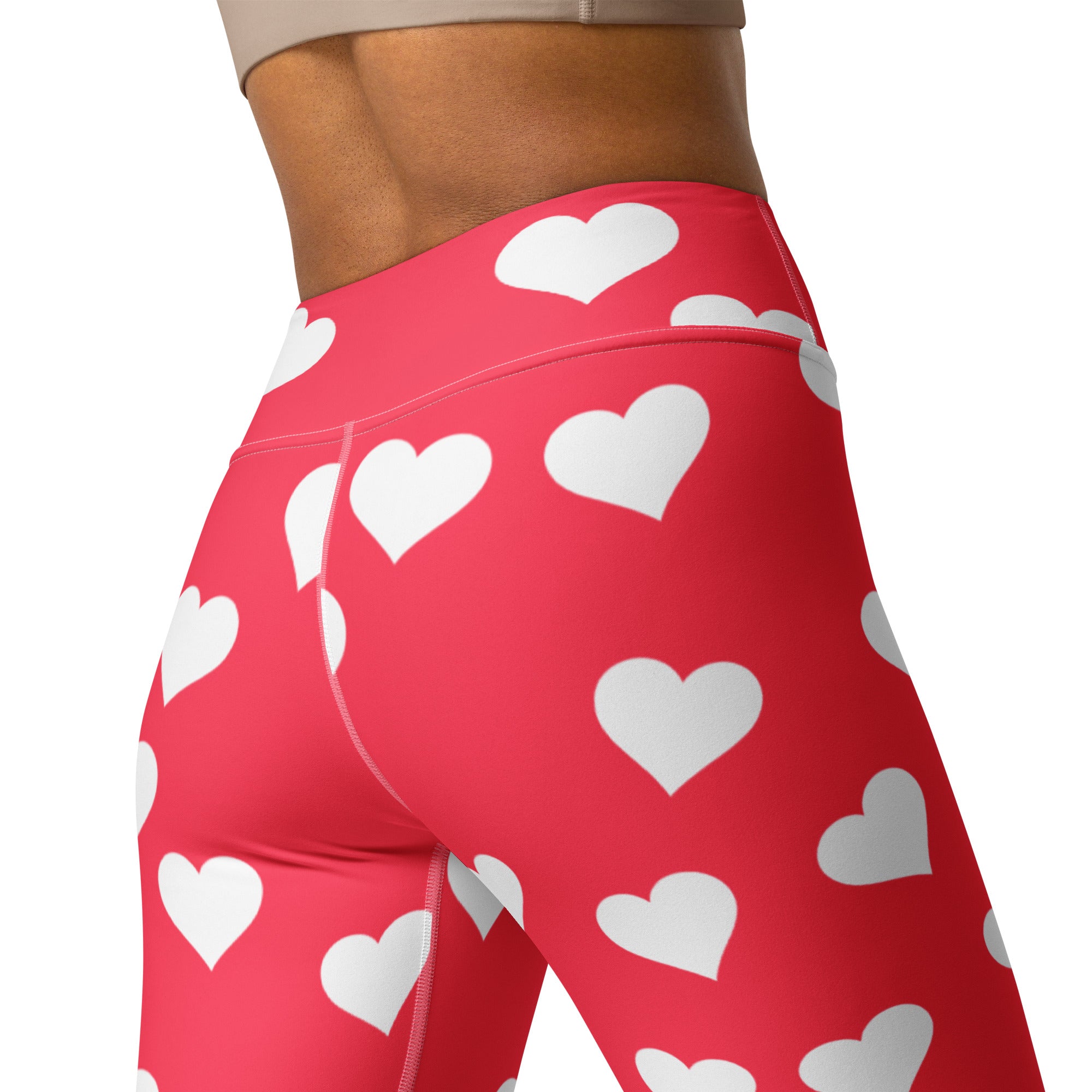 Women’s bright pink high waisted buttery soft yoga leggings with white heart print and quick drying fabric