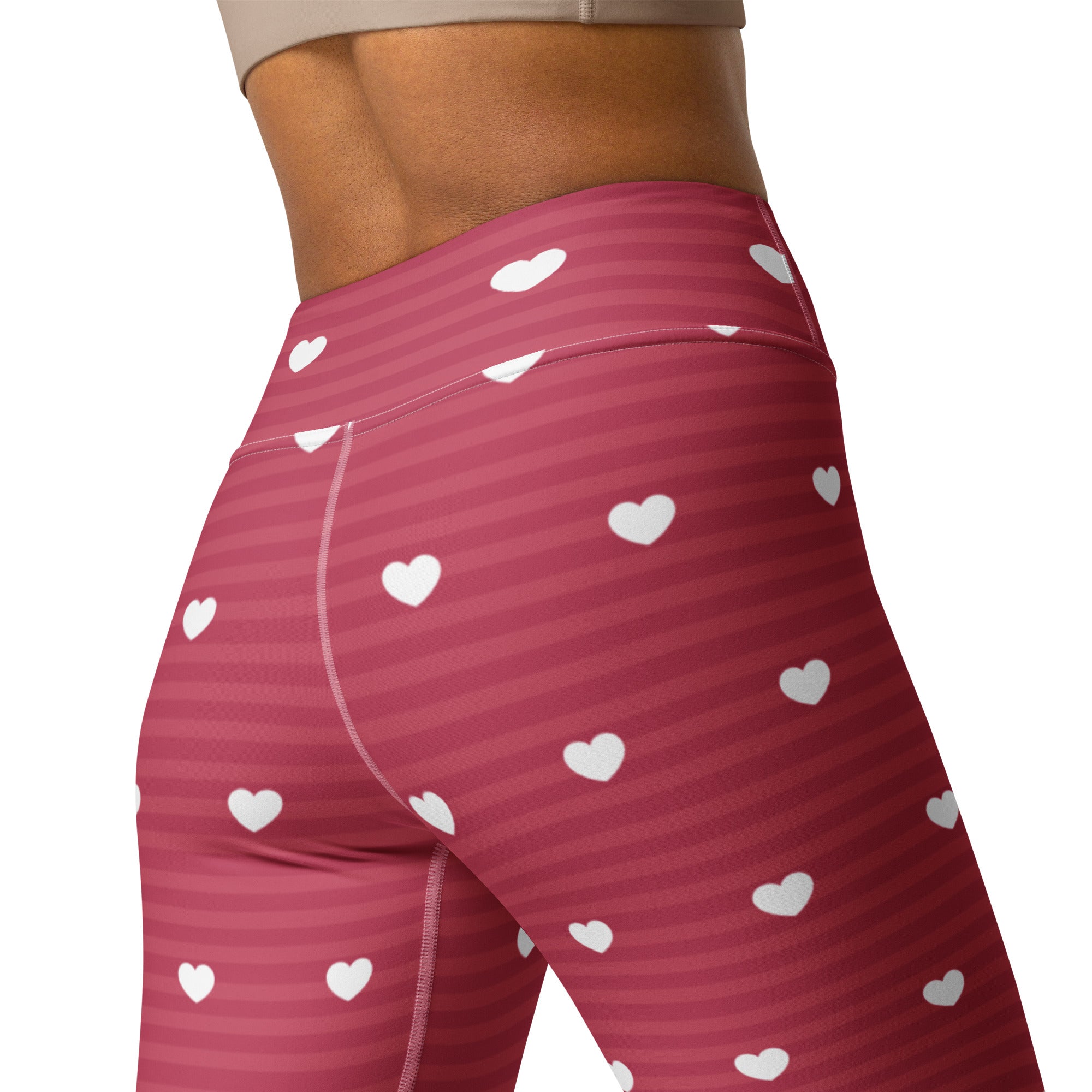 Women’s pink and white heart-patterned high waisted buttery soft yoga leggings with diagonal stripes and quick drying fabric