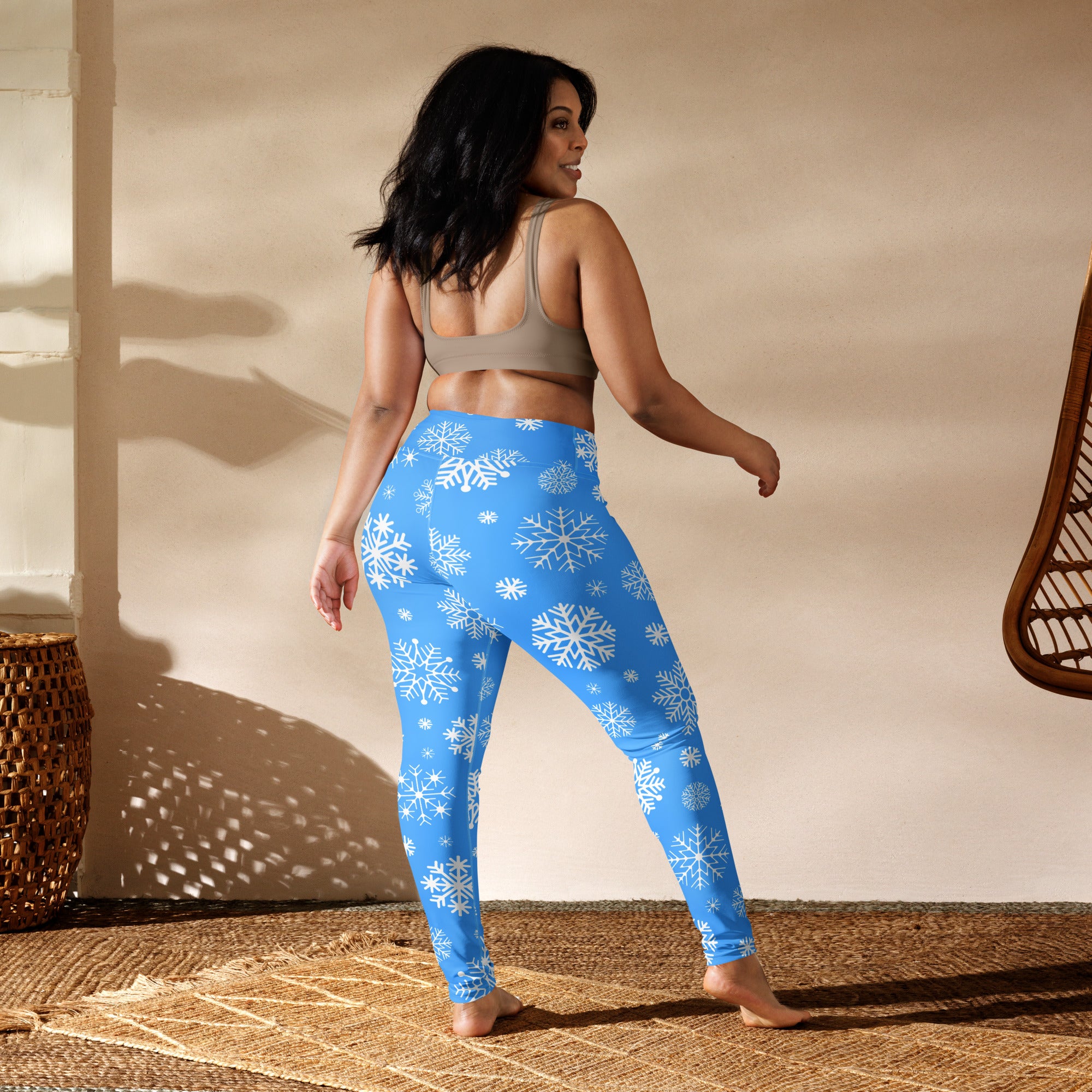 Blue women’s buttery soft yoga leggings with white snowflake patterns ideal for winter workouts