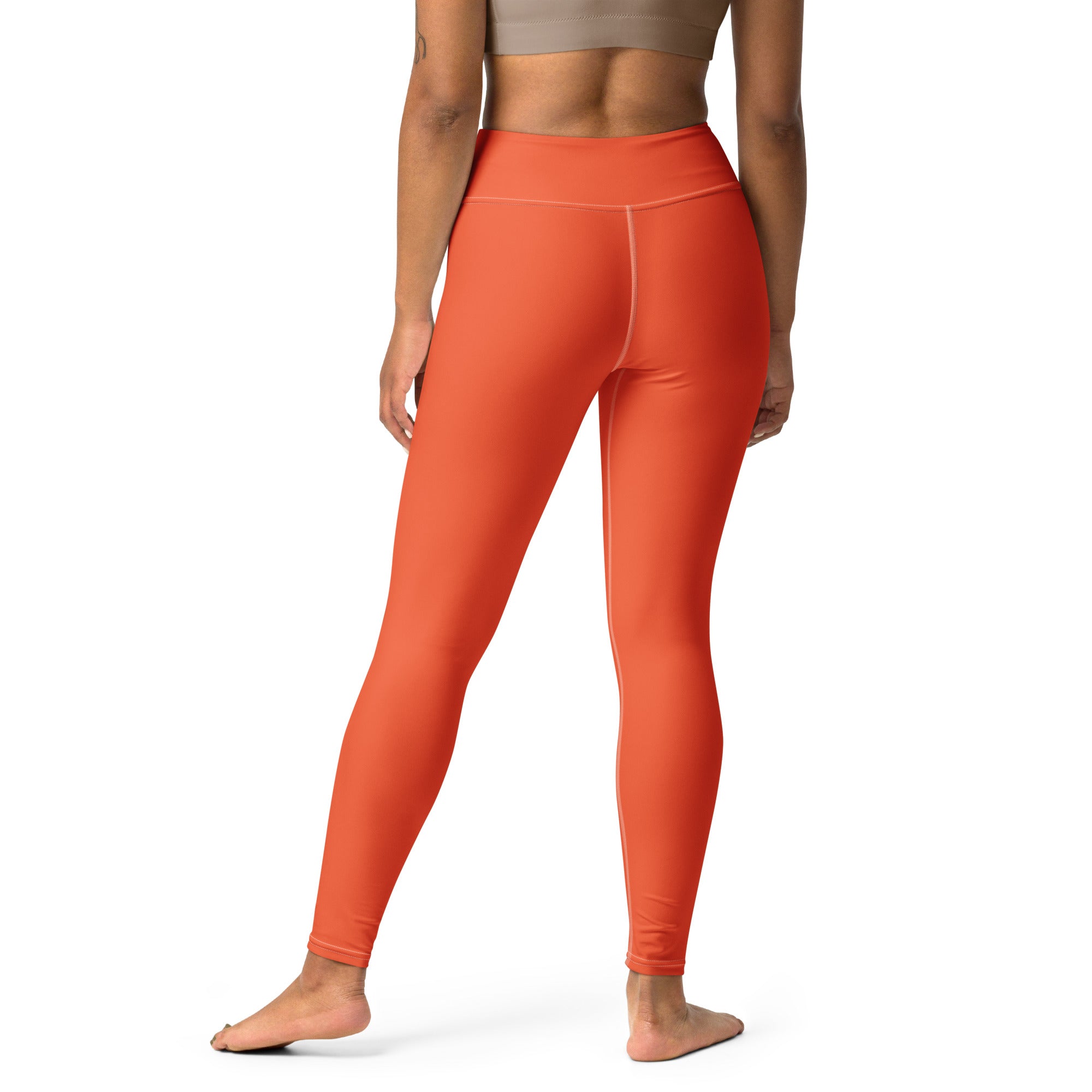A pair of high-waisted solid orange buttery soft stretchy yoga leggings for women