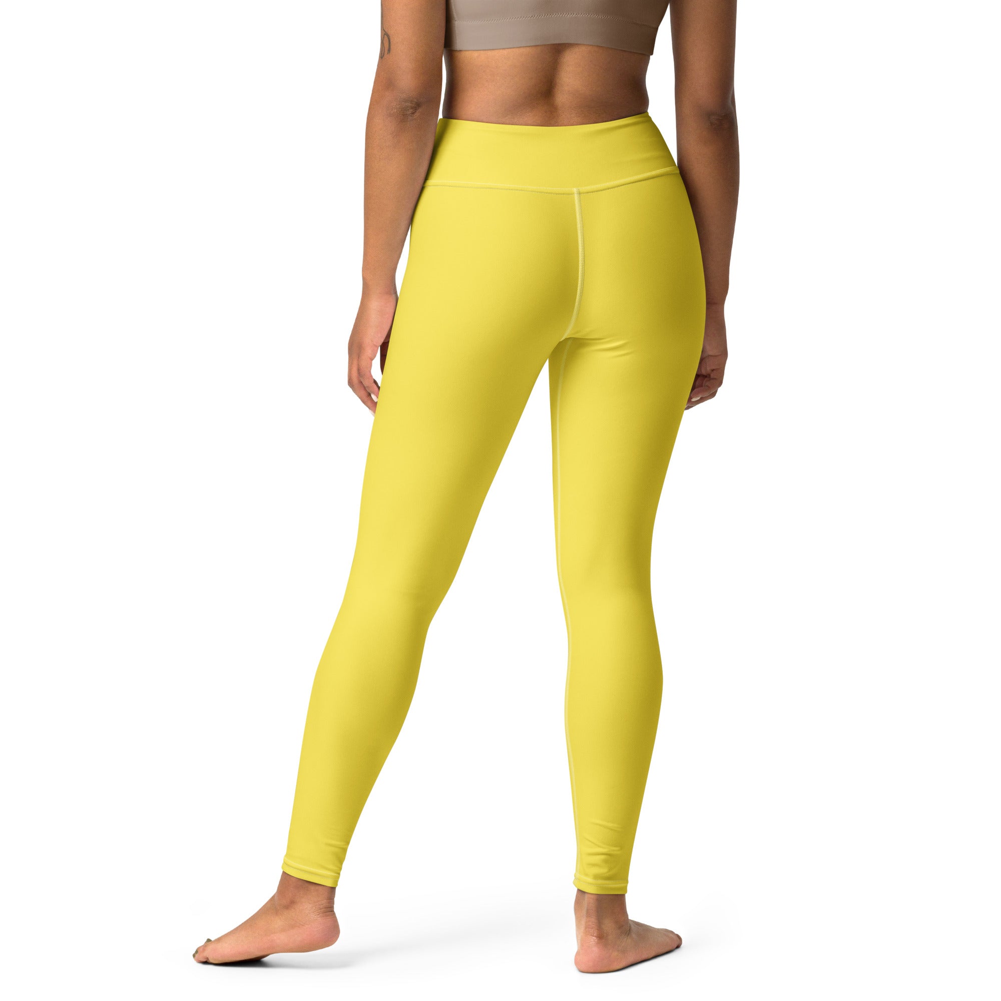 Bright yellow high-waisted women’s yoga leggings made of buttery soft stretchy form-fitting fabric