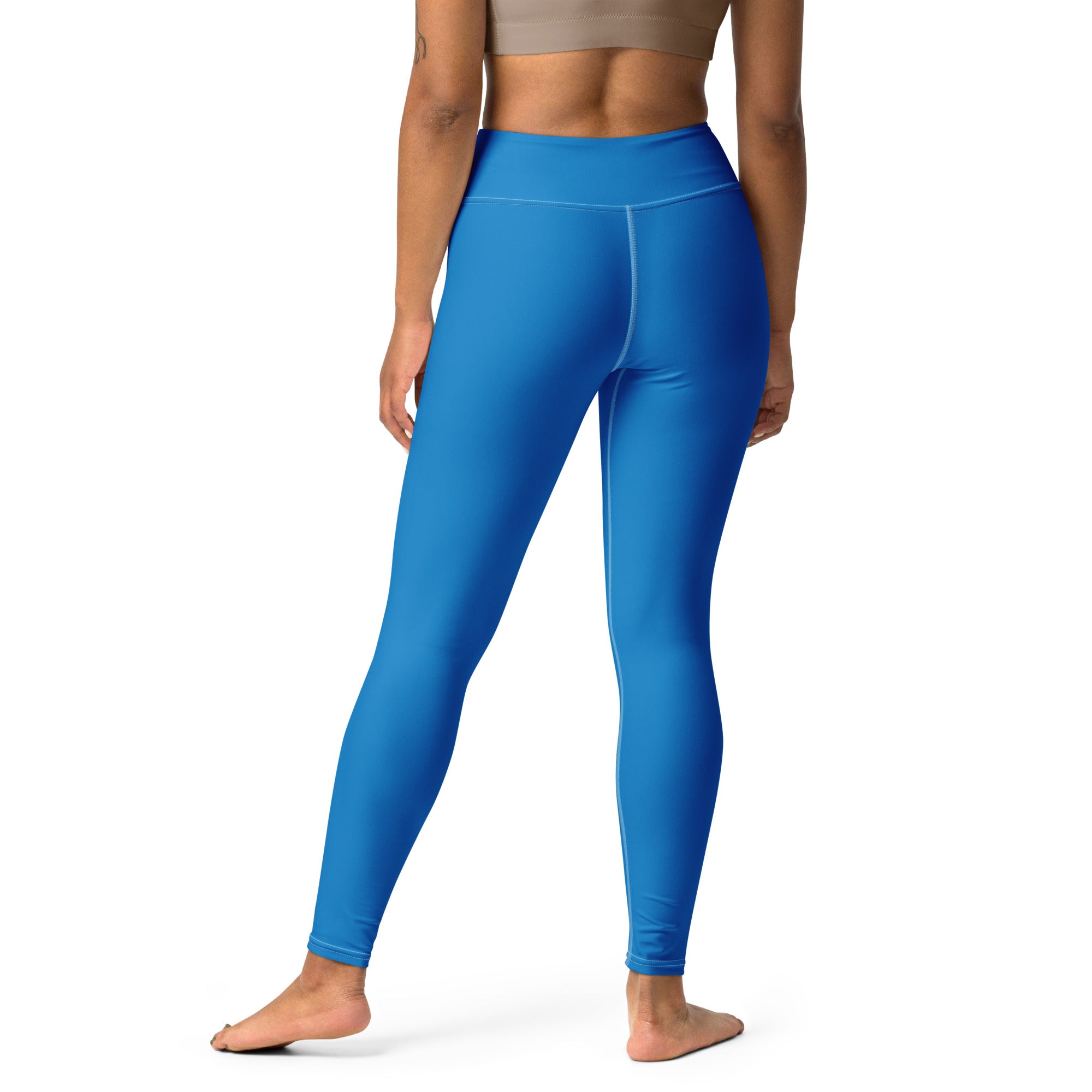 Bright blue high-waisted buttery soft yoga leggings made of stretchy form-fitting fabric for women