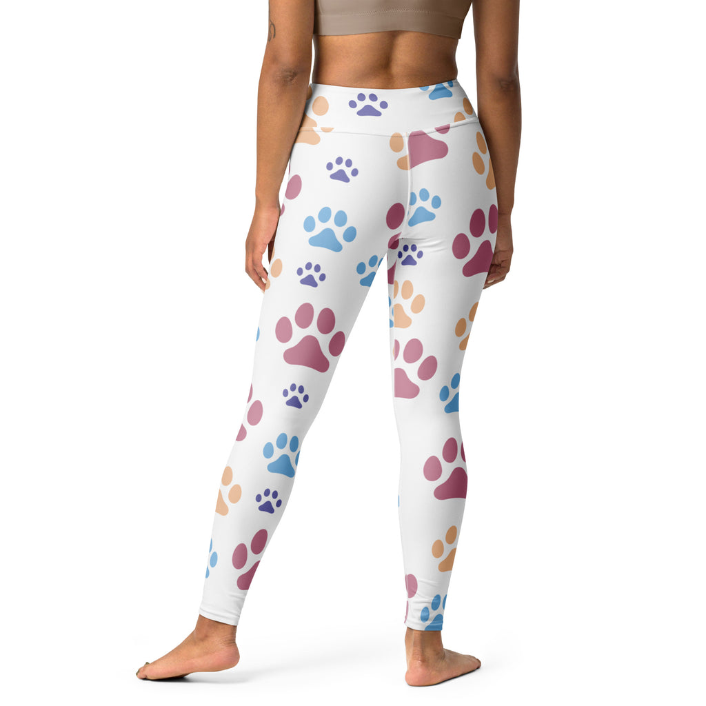 White buttery soft women’s yoga leggings with colorful pink blue and beige paw print pattern
